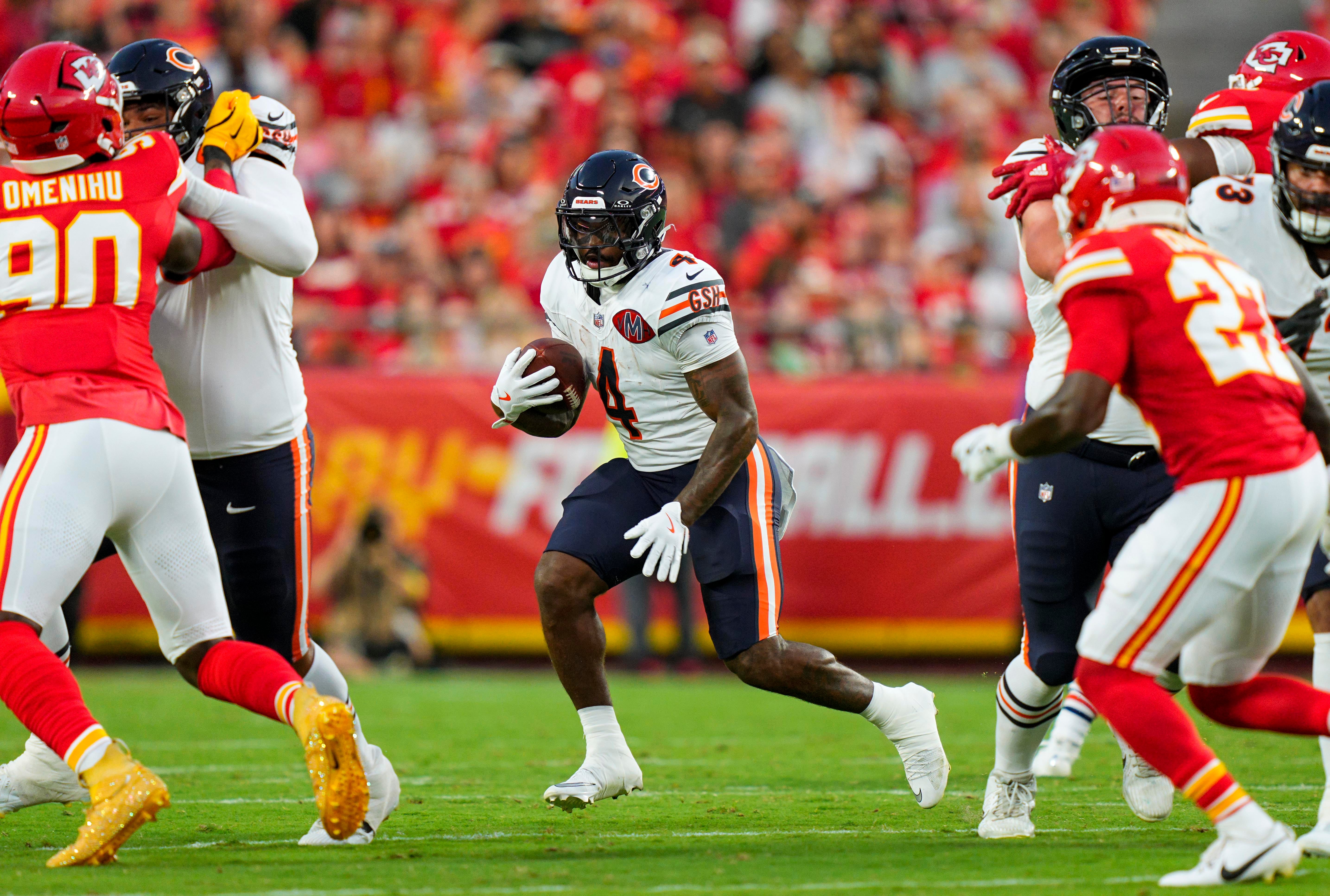 Aug 22, 2025; Kansas City, Missouri, USA; Chicago Bears running back D'Andre Swift (4) runs the ball during the first half against the Kansas City Chiefs at GEHA Field at Arrowhead Stadium.