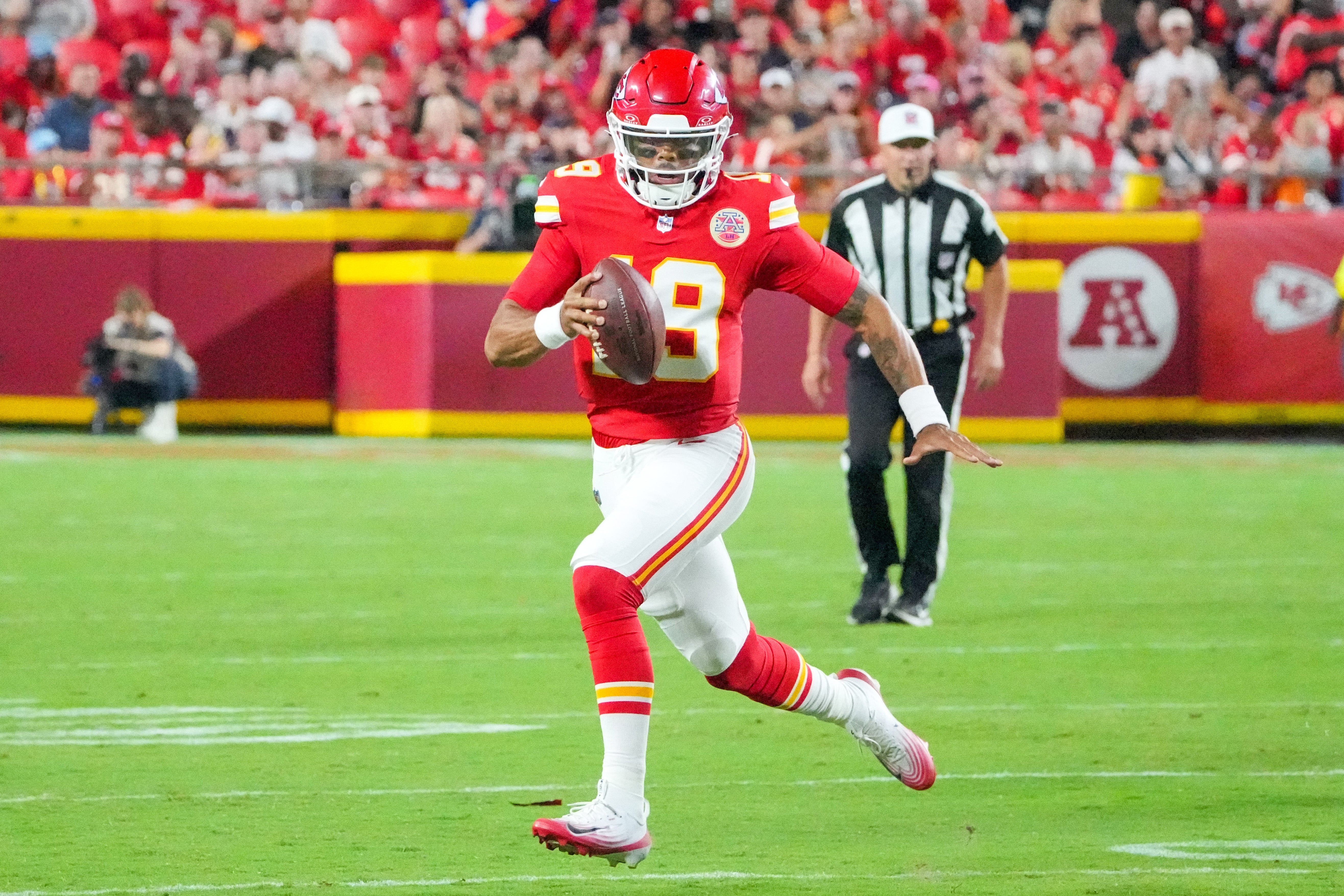 Kansas City Chiefs quarterback Chris Oladokun (19) runs the ball against the Chicago Bears during the second half of the game at GEHA Field at Arrowhead Stadium.