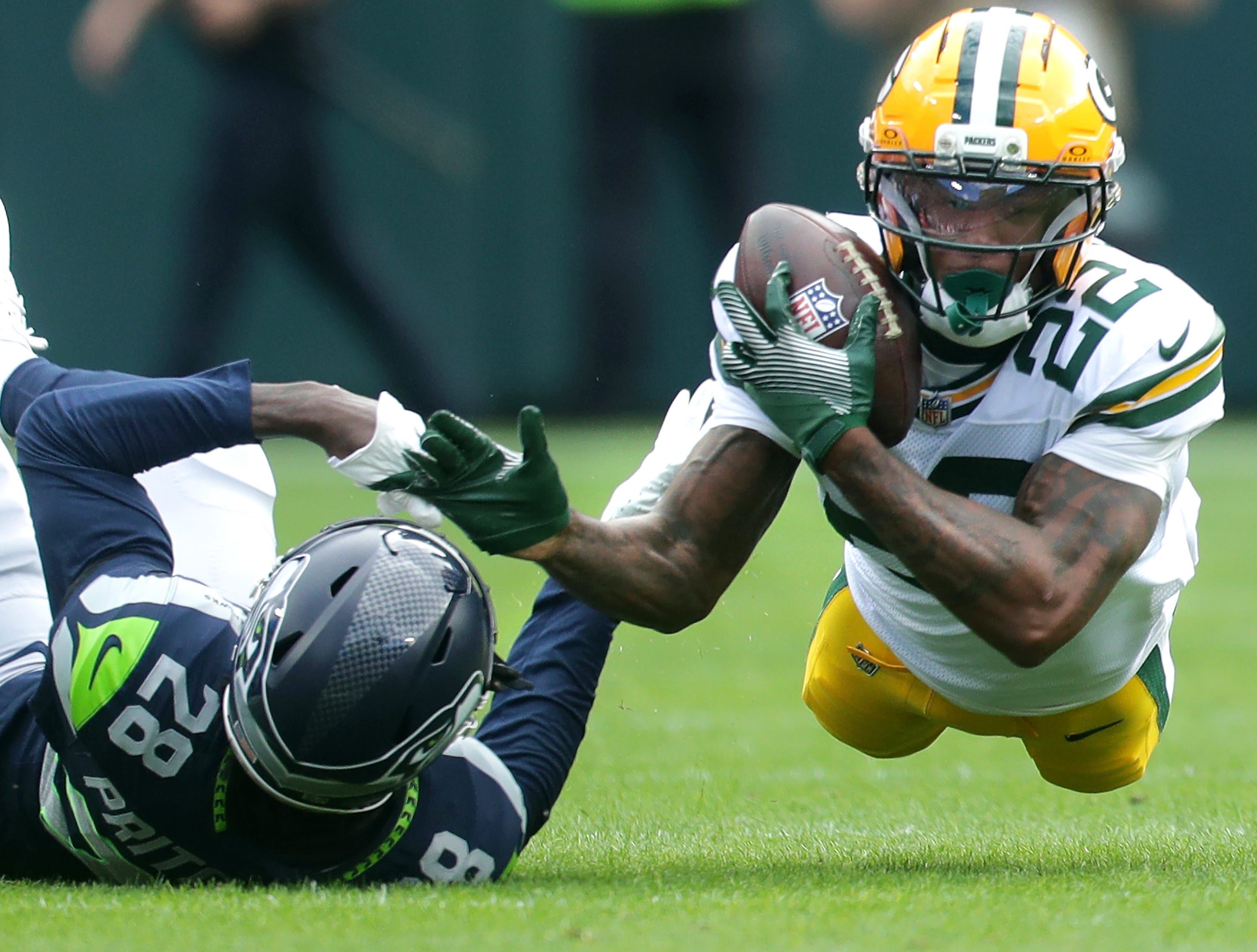Green Bay Packers wide receiver Matthew Golden (22) catches a pass agains the defense of Seattle Seahawks cornerback Nehemiah Pritchett (28) on Saturday, August 23, 2025, at Lambeau Field in Green Bay, Wis. The Packers defeated the Seahawks 20-7.