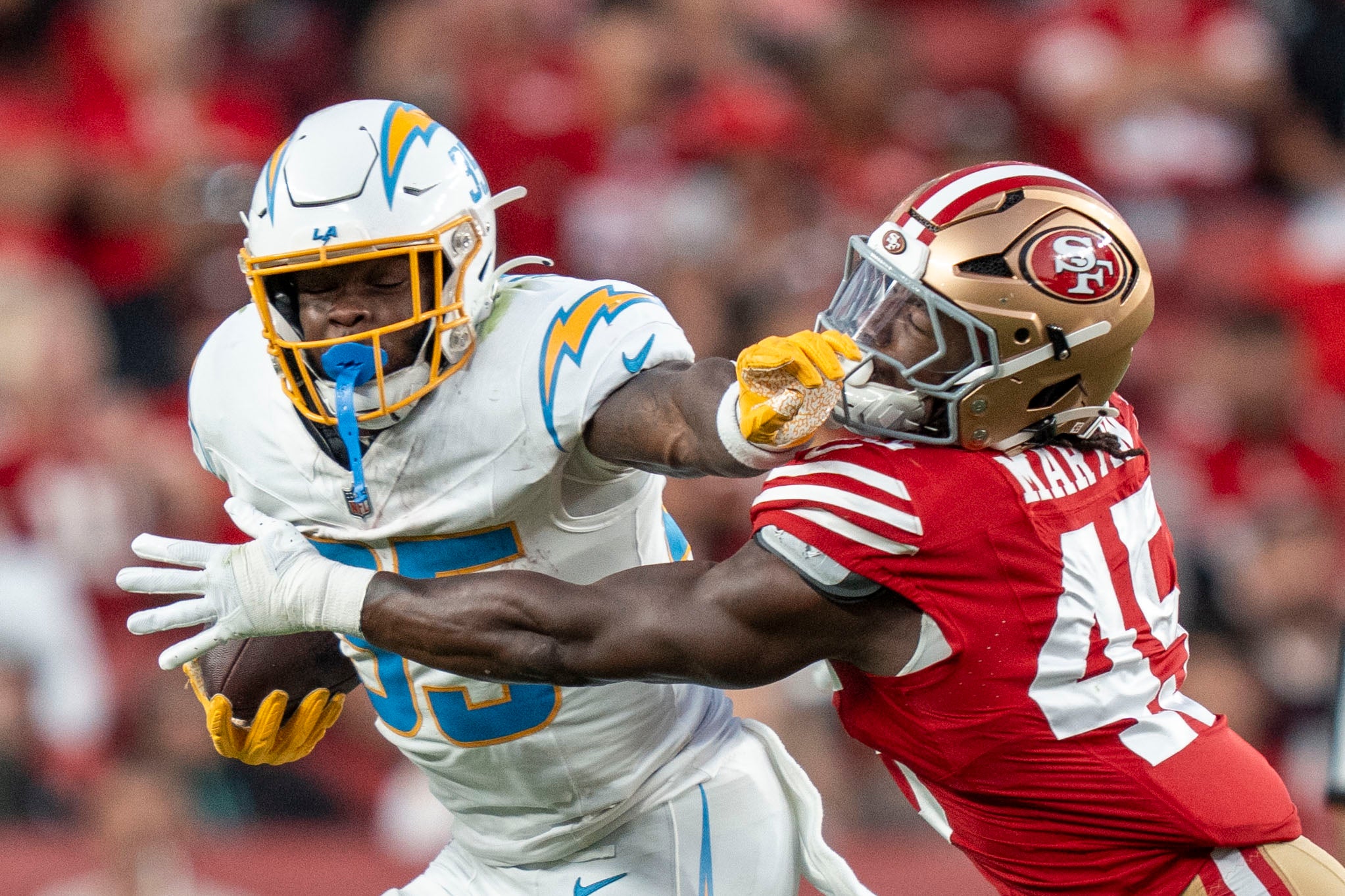 August 23, 2025; Santa Clara, California, USA; Los Angeles Chargers running back Raheim Sanders (35) runs the football against San Francisco 49ers linebacker Nick Martin (45) during the third quarter at Levi's Stadium. Mandatory Credit: Kyle Terada-Imagn Images