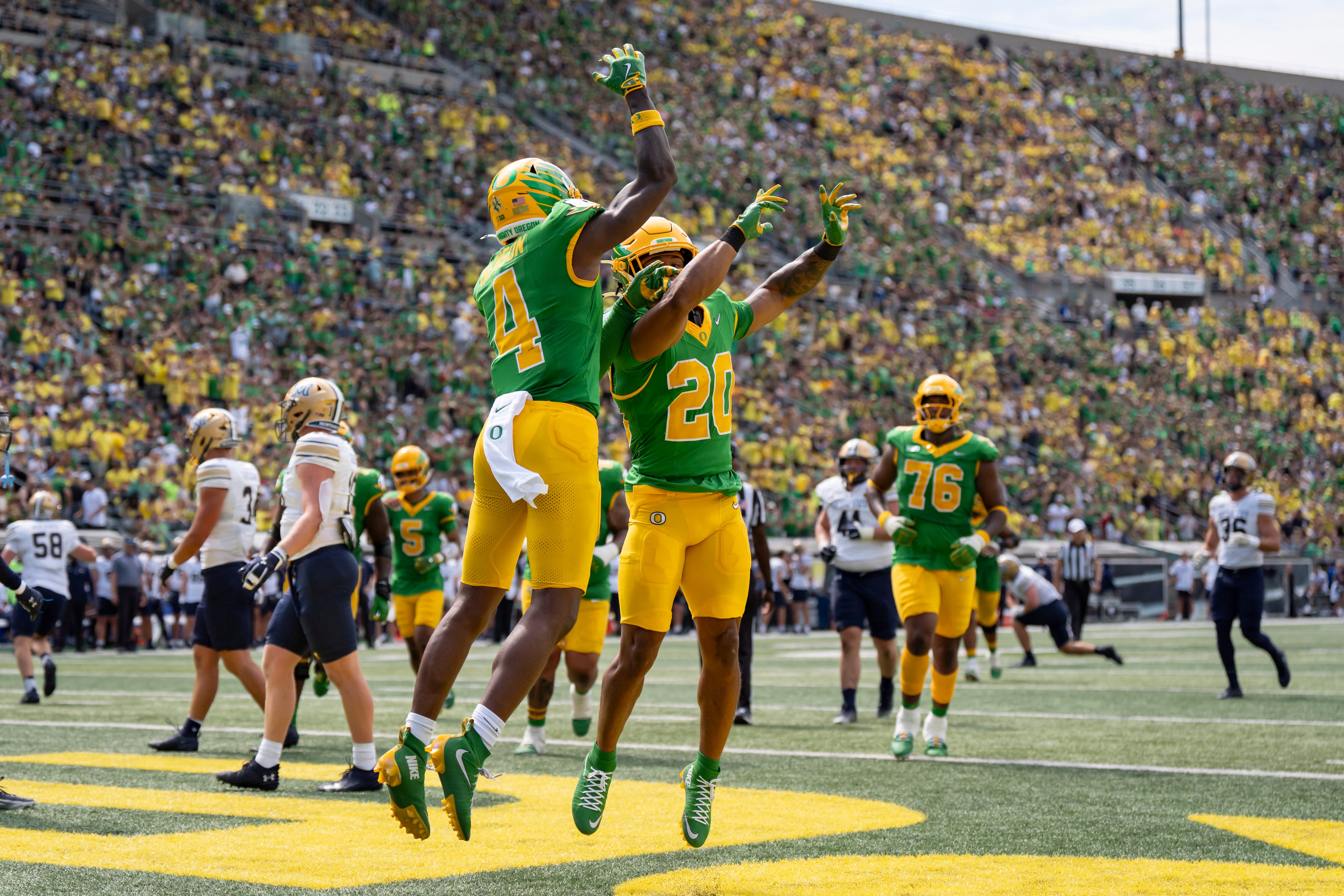 Oregon wide receiver Malik Benson, left, and running back Makhi Hughes celebrate a touchdown by Benson as the Oregon Ducks host the Montana State Bobcats on Aug. 30, 2025, at Autzen Stadium in Eugene, Oregon.
