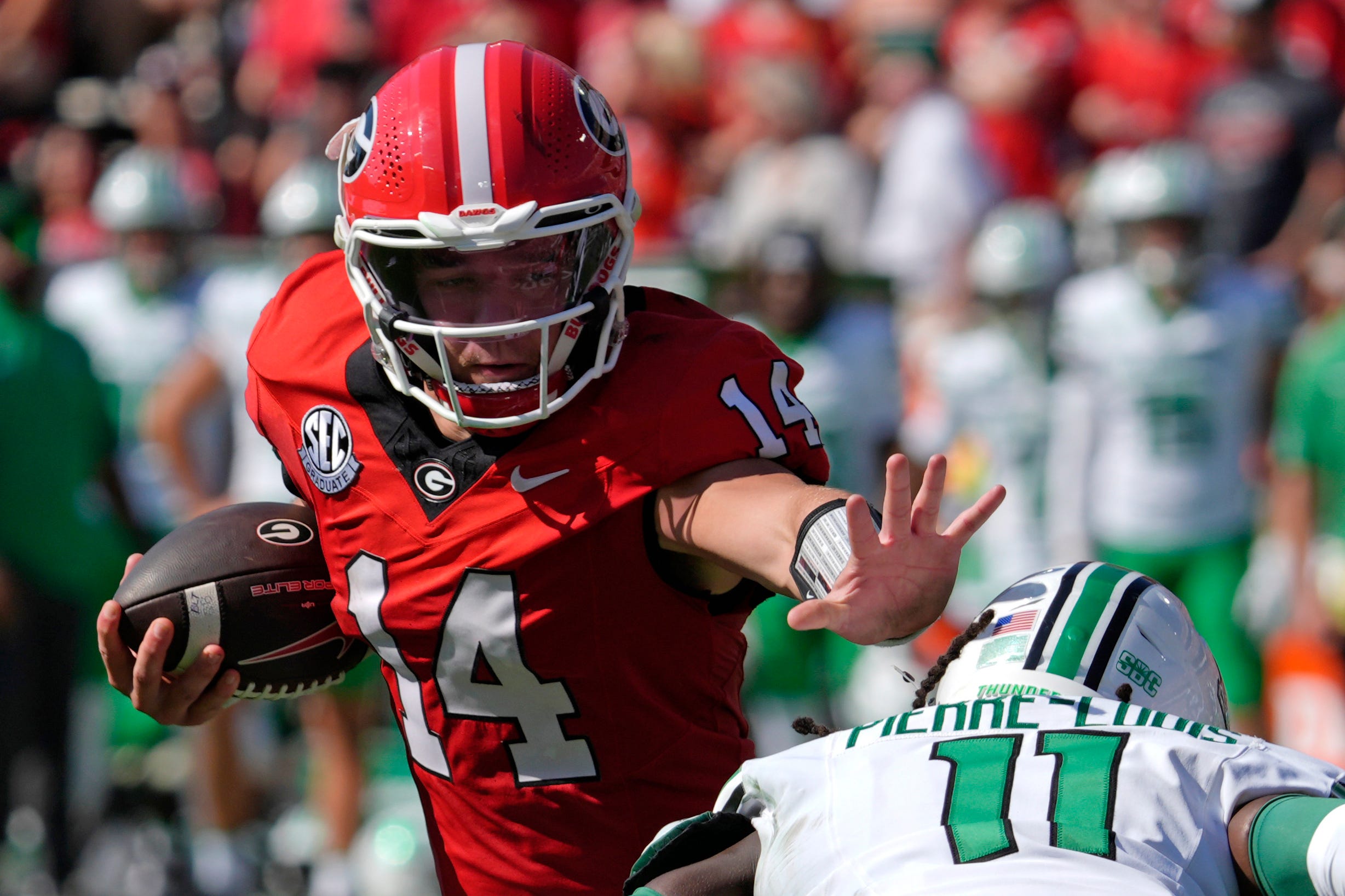 Georgia quarterback Gunner Stockton (14) runs the ball past Marshall defensive back Josh Pierre-Louis (11) during the first half of a NCAA college football game against Marshall in Athens, Ga., on Sat... Joshua L. Jones-USA TODAY NETWORK via Imagn Images