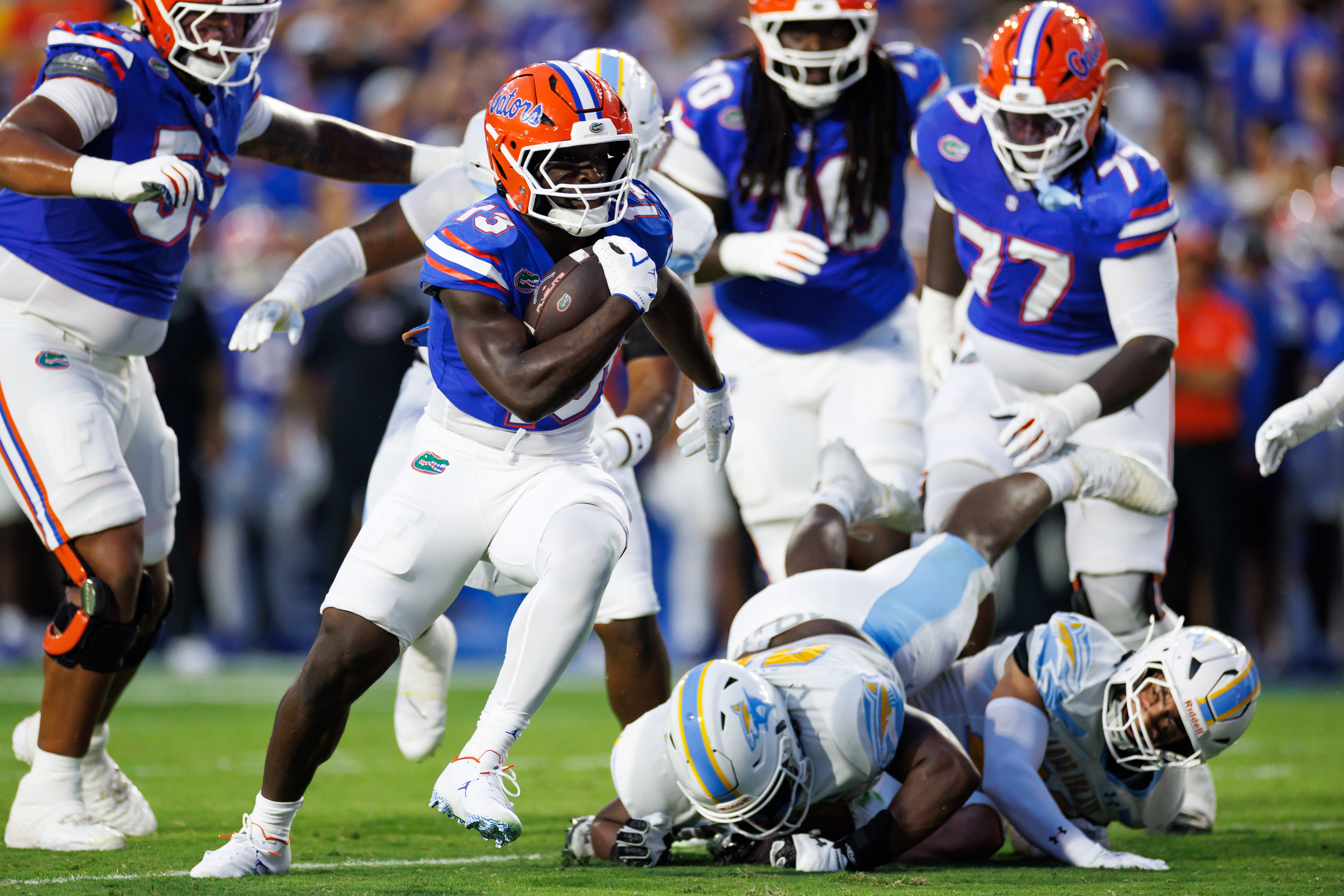 Aug 30, 2025; Gainesville, Florida, USA; Florida Gators running back Jadan Baugh (13) runs with the ball for a touchdown against the Long Island Sharks during the first half at Ben Hill Griffin Stadium.