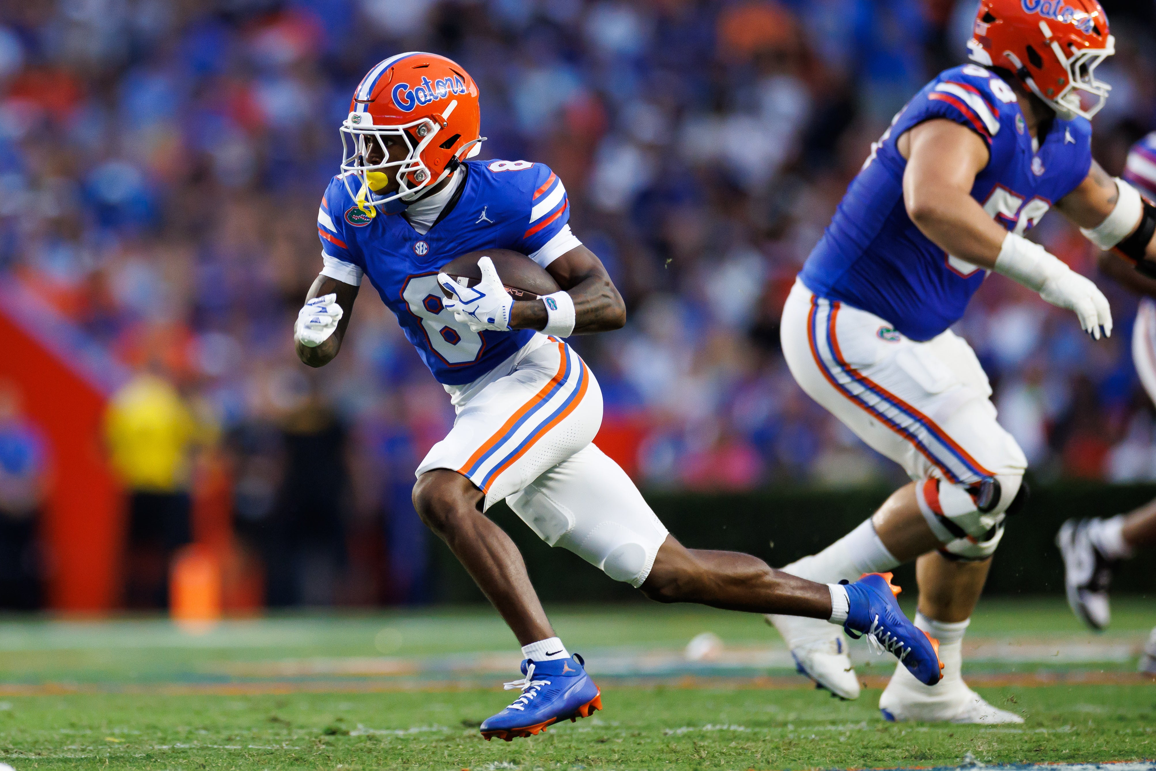 Aug 30, 2025; Gainesville, Florida, USA; Florida Gators wide receiver Vernell Brown III (8) runs with the ball against the Long Island Sharks during the first half at Ben Hill Griffin Stadium.
