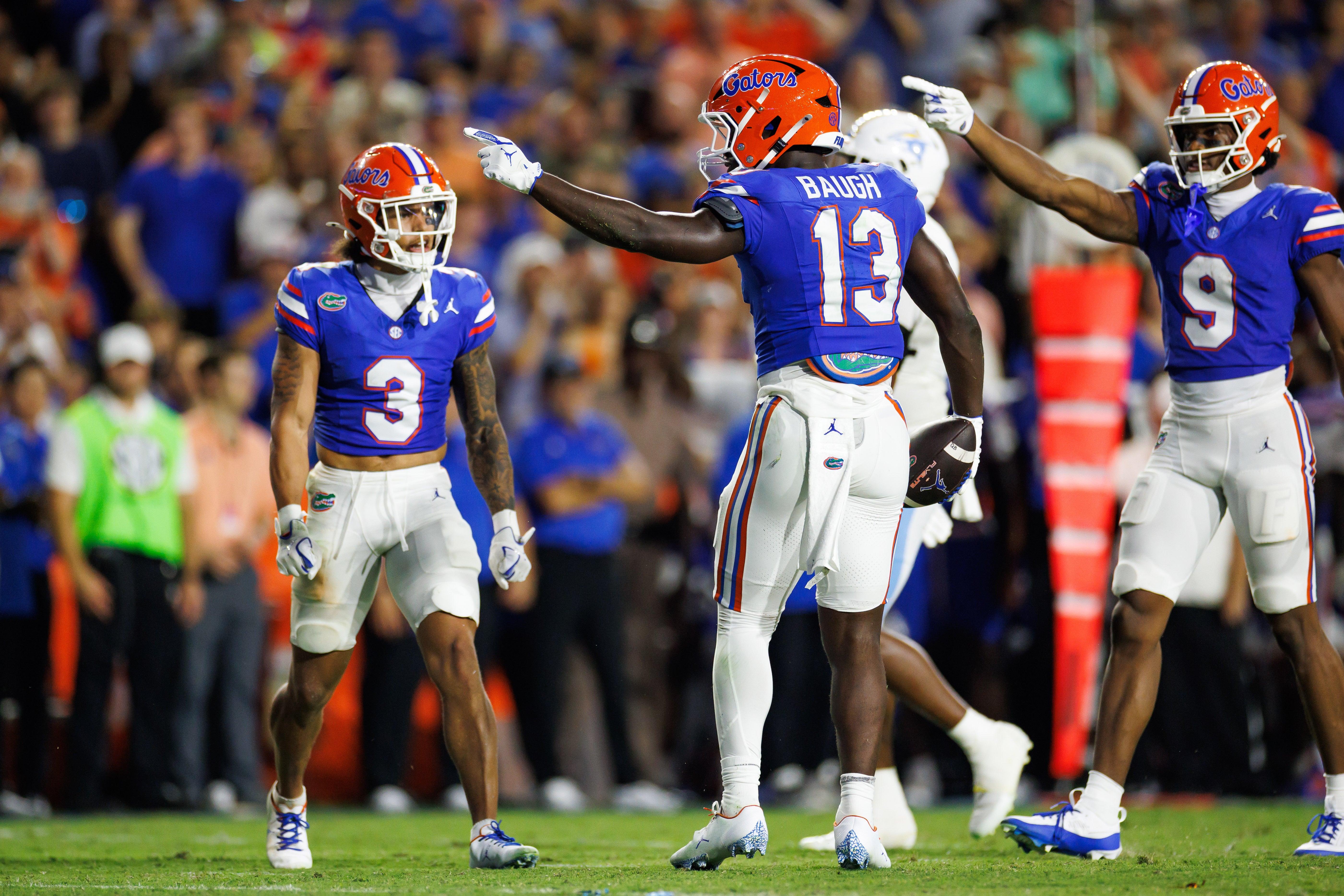 Aug 30, 2025; Gainesville, Florida, USA; Florida Gators running back Jadan Baugh (13) and Florida Gators wide receiver J. Michael Sturdivant (9) gesture after a run against the Long Island Sharks during the first half at Ben Hill Griffin Stadium.