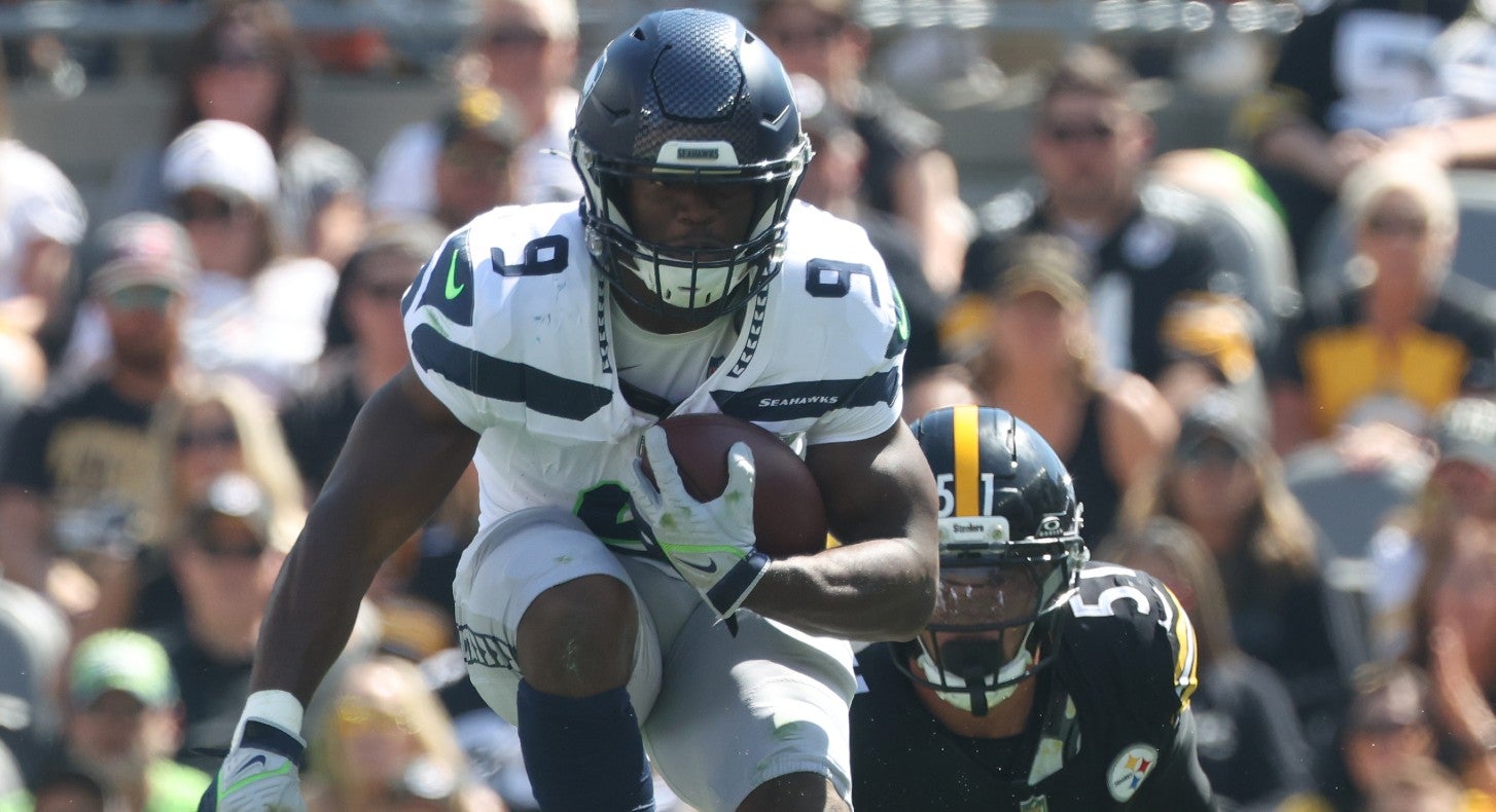 Sep 14, 2025; Pittsburgh, Pennsylvania, USA; Seattle Seahawks running back Kenneth Walker III (9) leaps over Pittsburgh Steelers defensive tackle Yaha Black (bottom) on a second quarter carry at Acrisure Stadium.