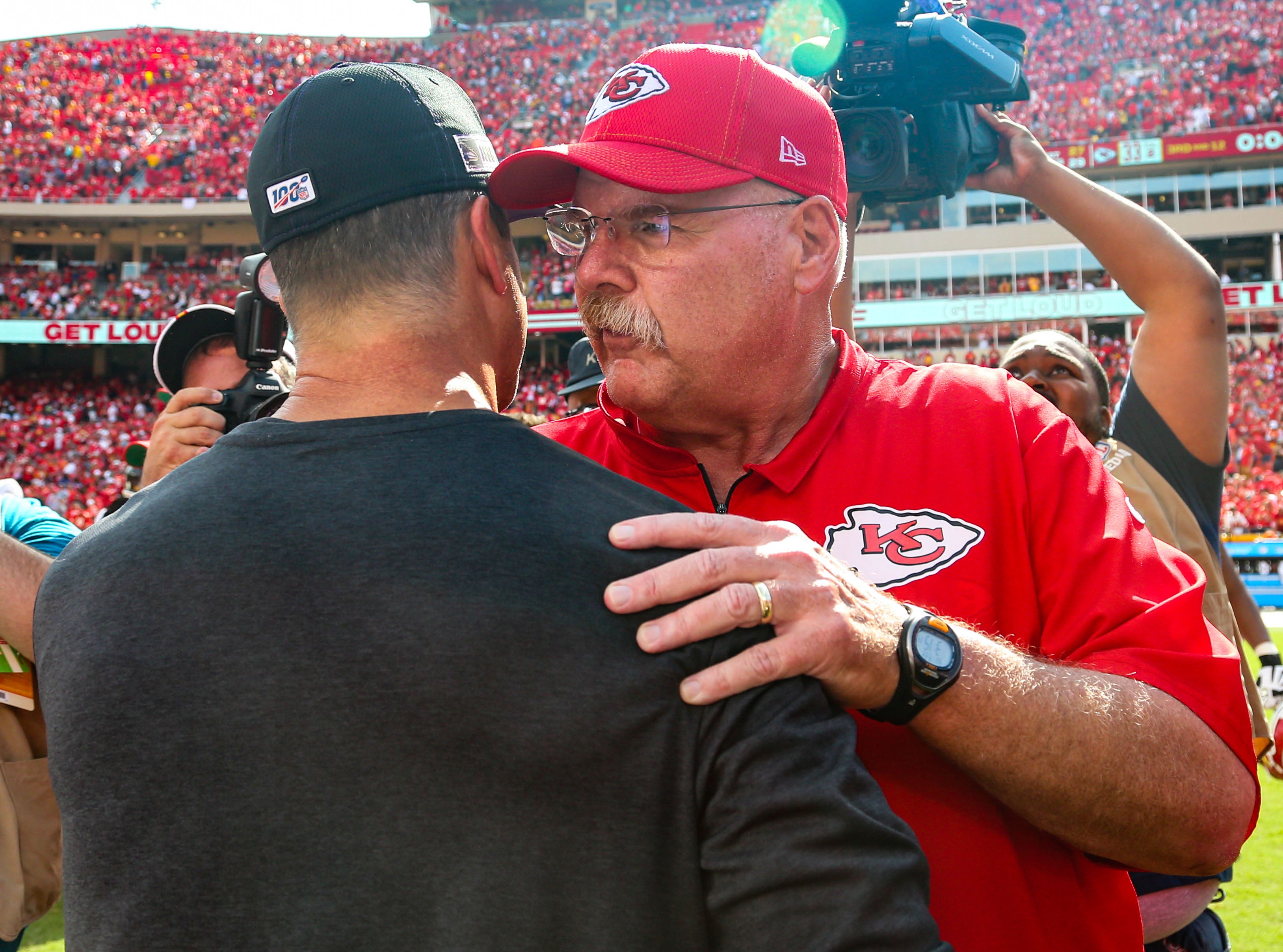 Kansas City Chiefs head coach Andy Reid talks with Baltimore Ravens head coach John Harbaugh