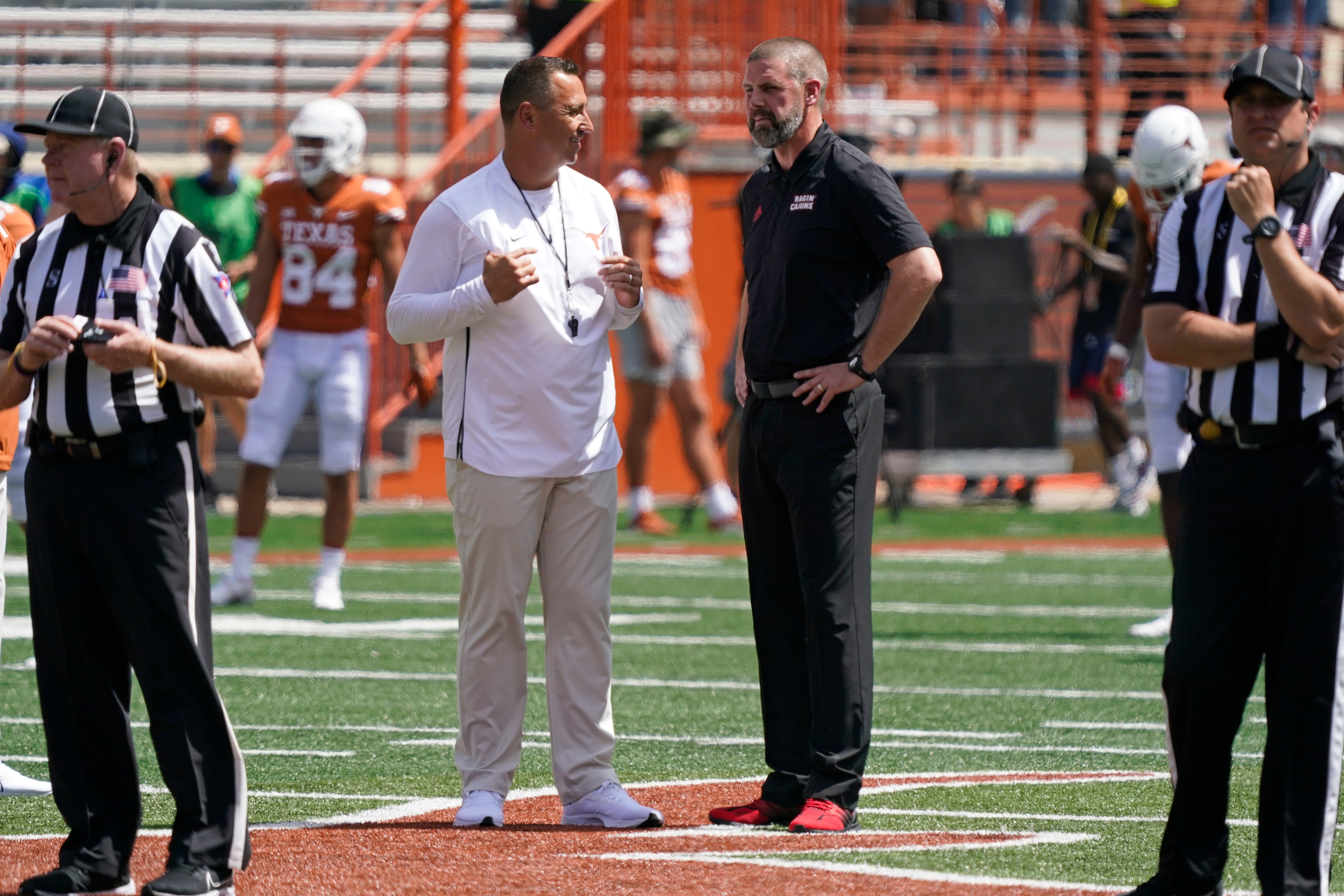 Sep 4, 2021; Austin, Texas, USA; Texas Longhorns head coach Steve Sarkisian talks with Louisiana Ragin' Cajuns head coach Billy Napier midfield before their game at Darrell K Royal-Texas Memorial Stadium.