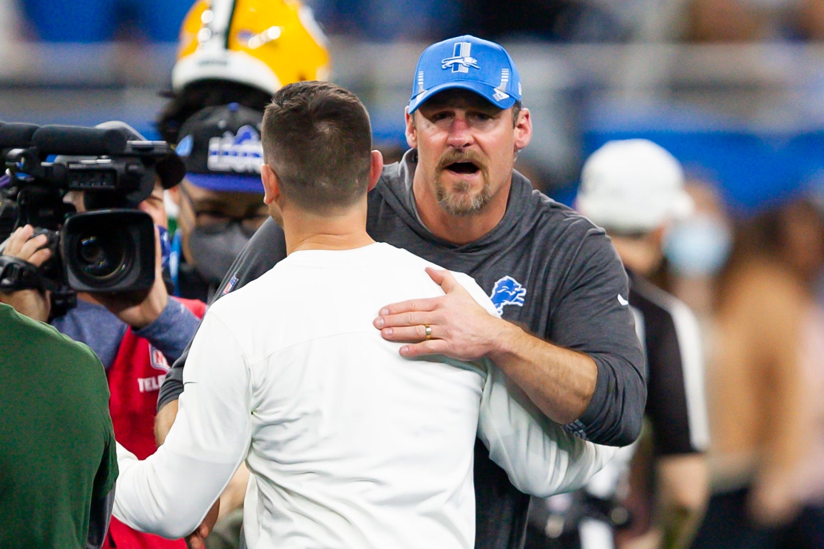 Jan 9, 2022; Detroit, Michigan, USA; Detroit Lions head coach Dan Campbell hugs Green Bay Packers head coach Matt LaFleur after the game at Ford Field.