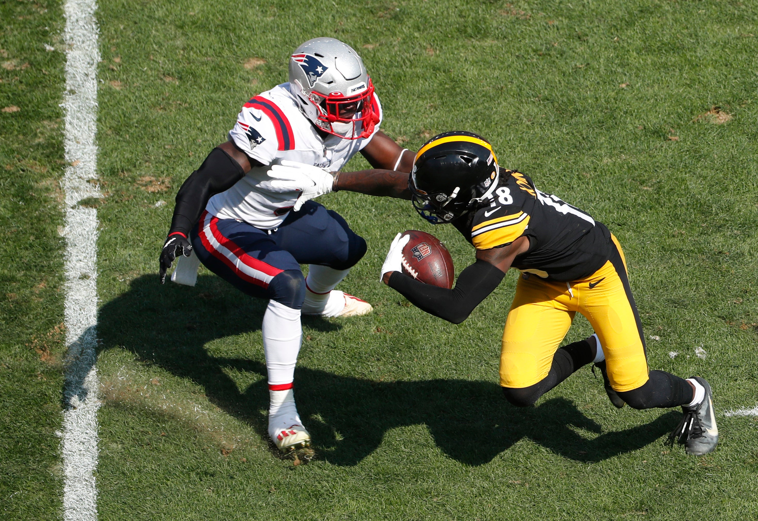 Sep 18, 2022; Pittsburgh, Pennsylvania, USA; Pittsburgh Steelers wide receiver Diontae Johnson (18) runs after a catch against New England Patriots safety Jabrill Peppers (3) during the third quarter at Acrisure Stadium. The Patriots won 17-14.