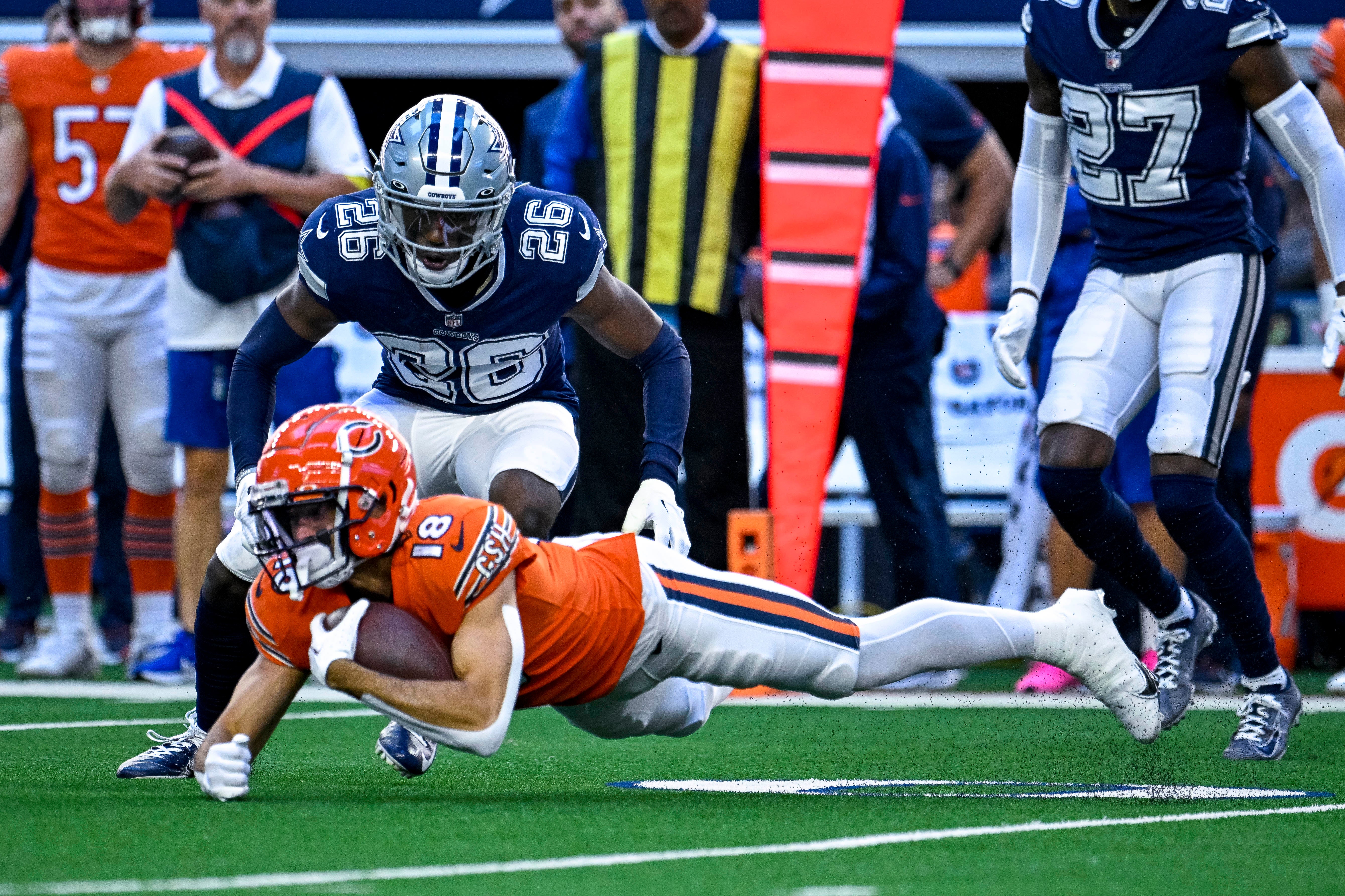Oct 30, 2022; Arlington, Texas, USA; Chicago Bears wide receiver Dante Pettis (18) leaps forward in front of Dallas Cowboys cornerback DaRon Bland (26) during the first quarter at AT&T Stadium.