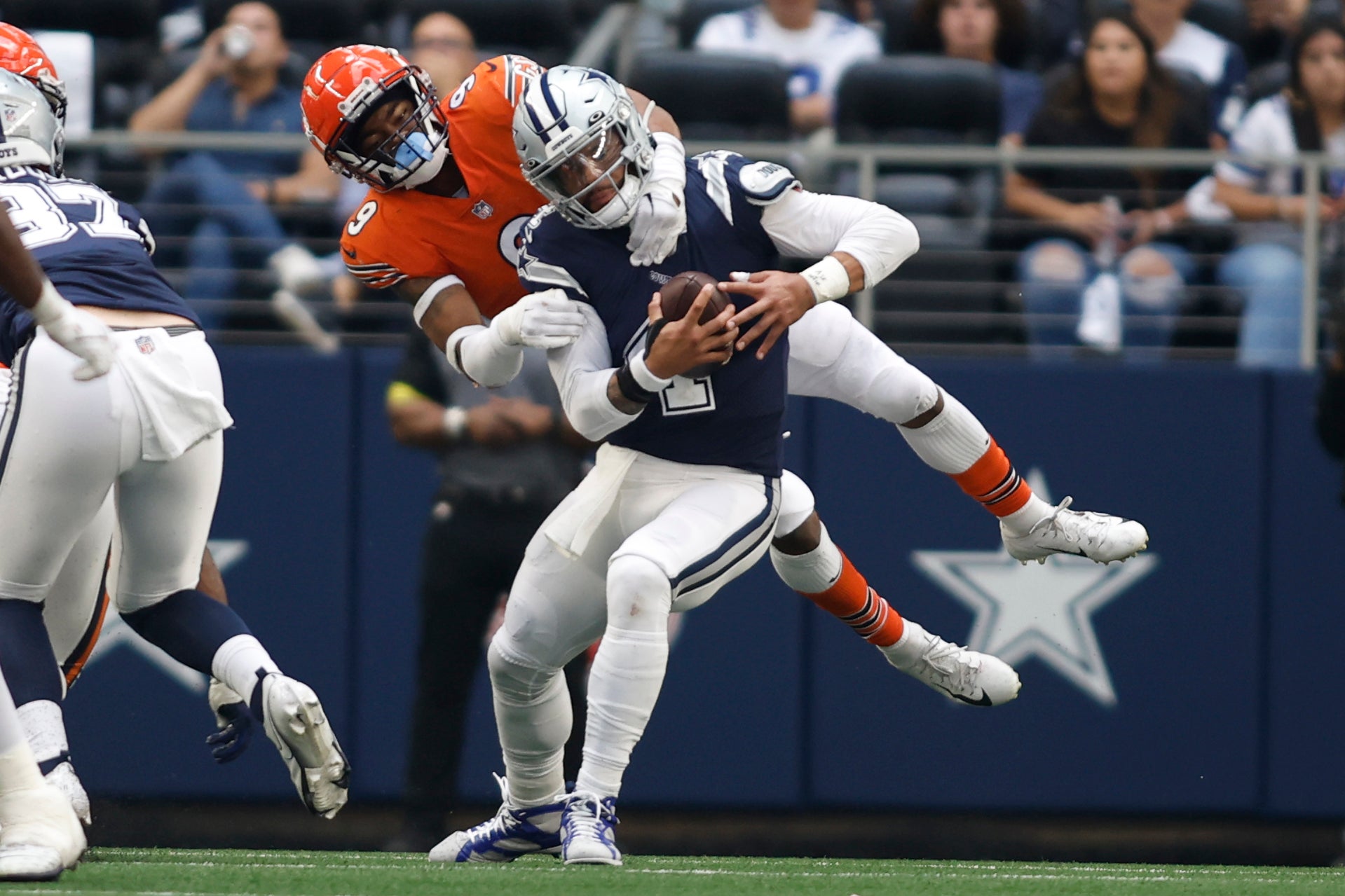 Oct 30, 2022; Arlington, Texas, USA; Chicago Bears safety Jaquan Brisker (9) sacks Dallas Cowboys quarterback Dak Prescott (4) in the fourth quarter at AT&T Stadium.