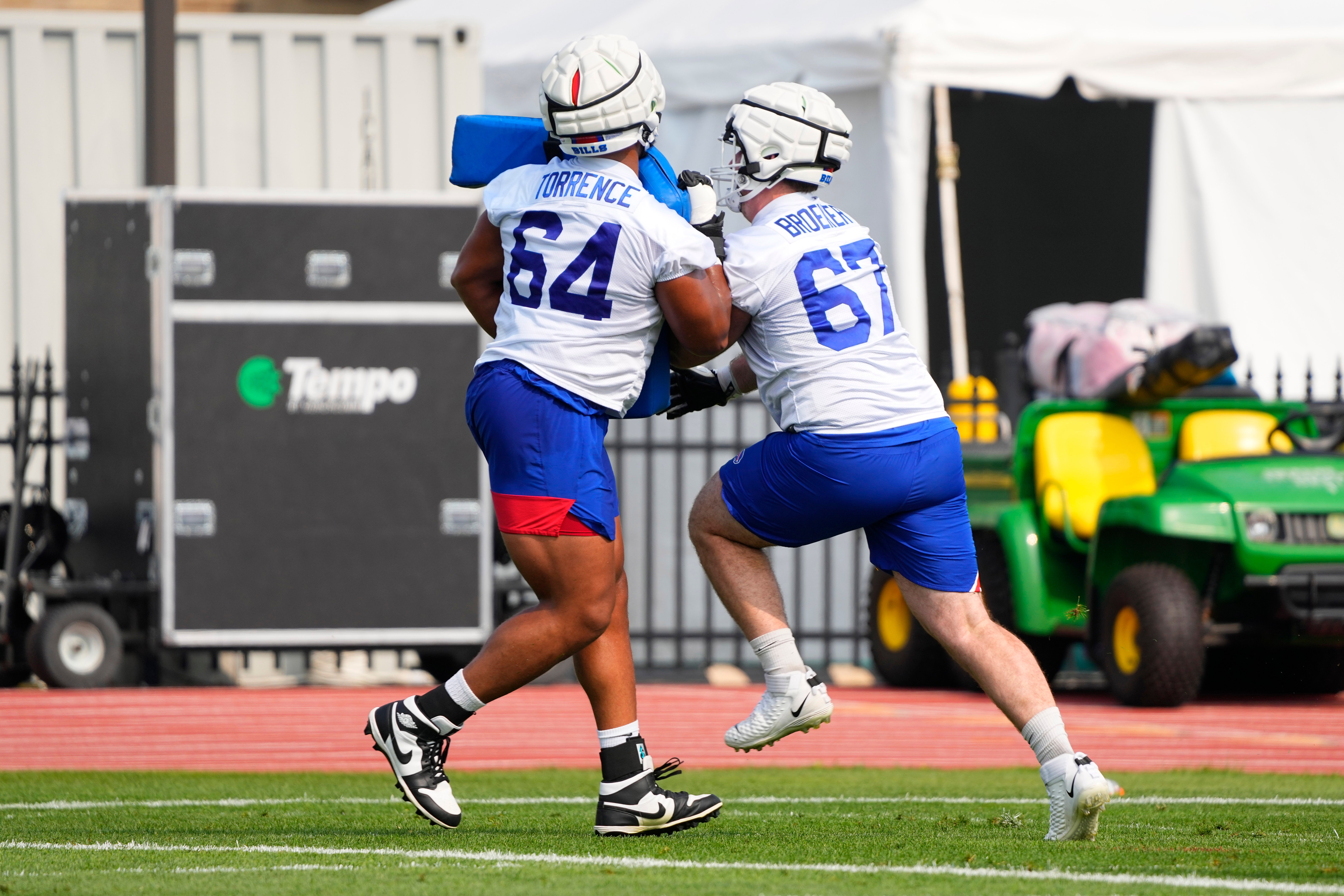 Jul 26, 2023; Rochester, NY, USA; Buffalo Bills guard O'Cyrun Torrence (64) and Buffalo Bills guard Nick Broeker (67) participate in blocking drills during training camp at St. John Fisher College.
