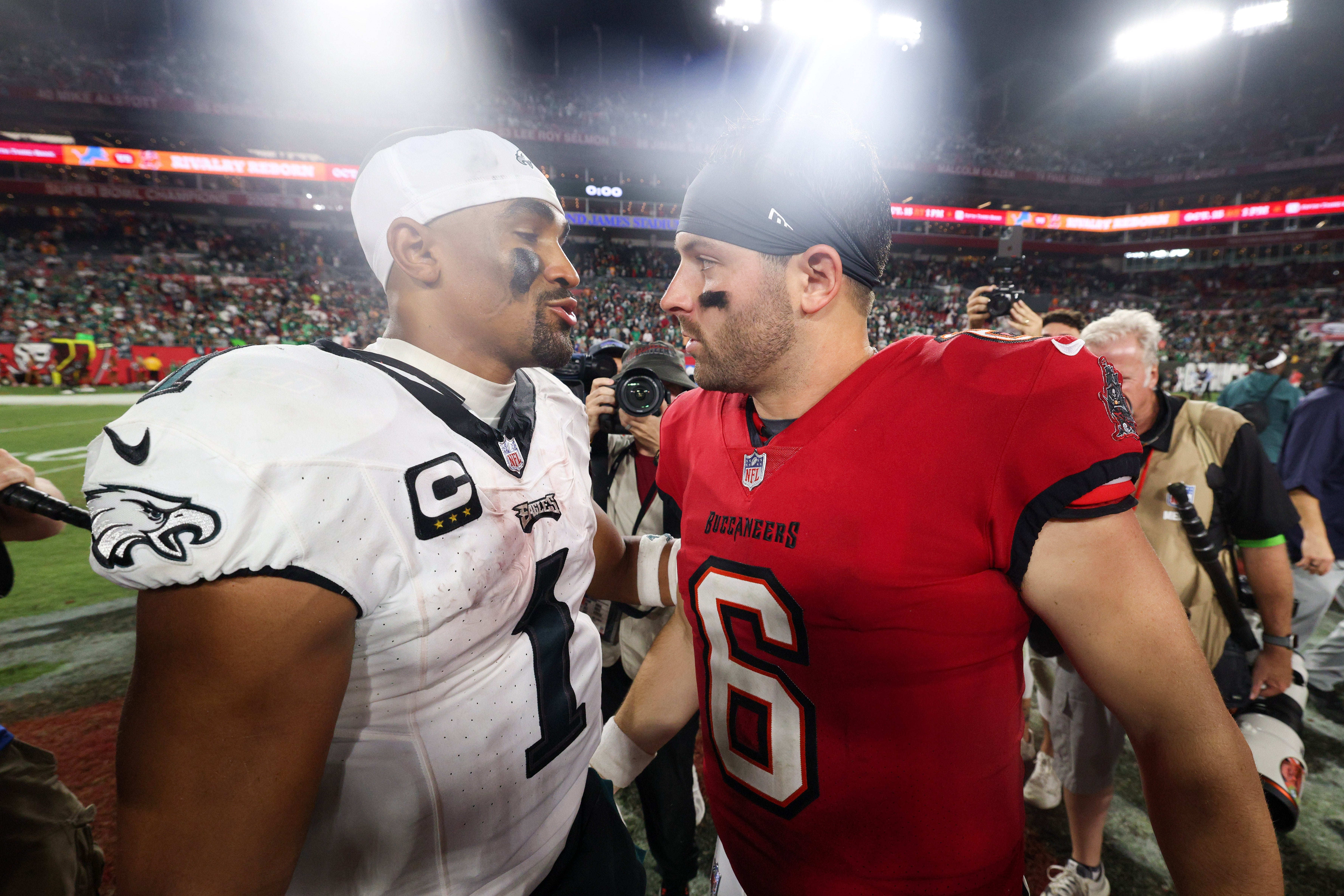 Philadelphia Eagles quarterback Jalen Hurts (1) and Tampa Bay Buccaneers quarterback Baker Mayfield (6) shake hands after a game at Raymond James Stadium.
