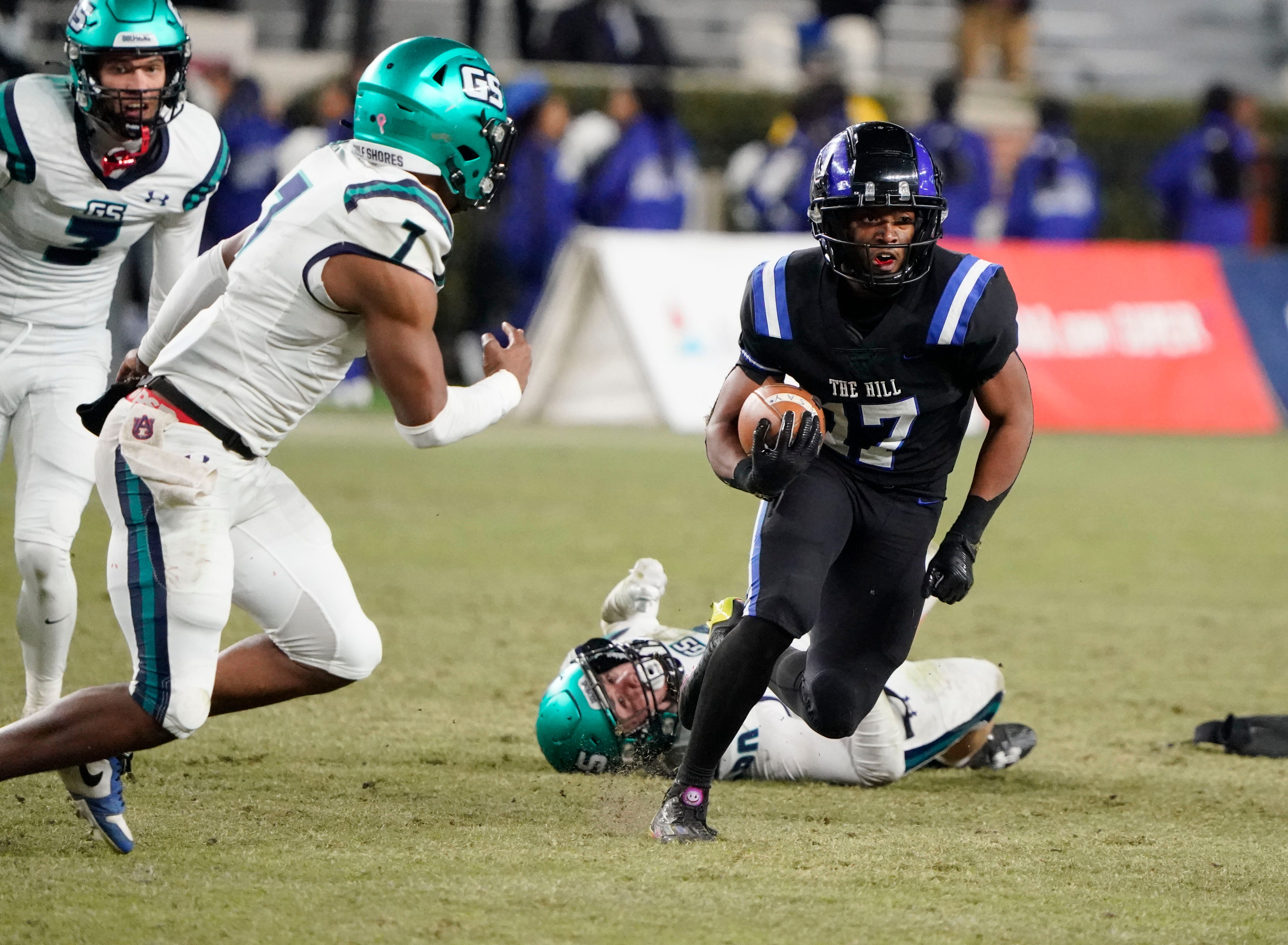 Ramsay’s Jayden Martin runs the ball and is pursued by Gulf Shores' Jamichael Garrett (7) during the 5A AHSAA State Championship Game in Bryant-Denny Stadium Thursday, Dec. 7, 2023.