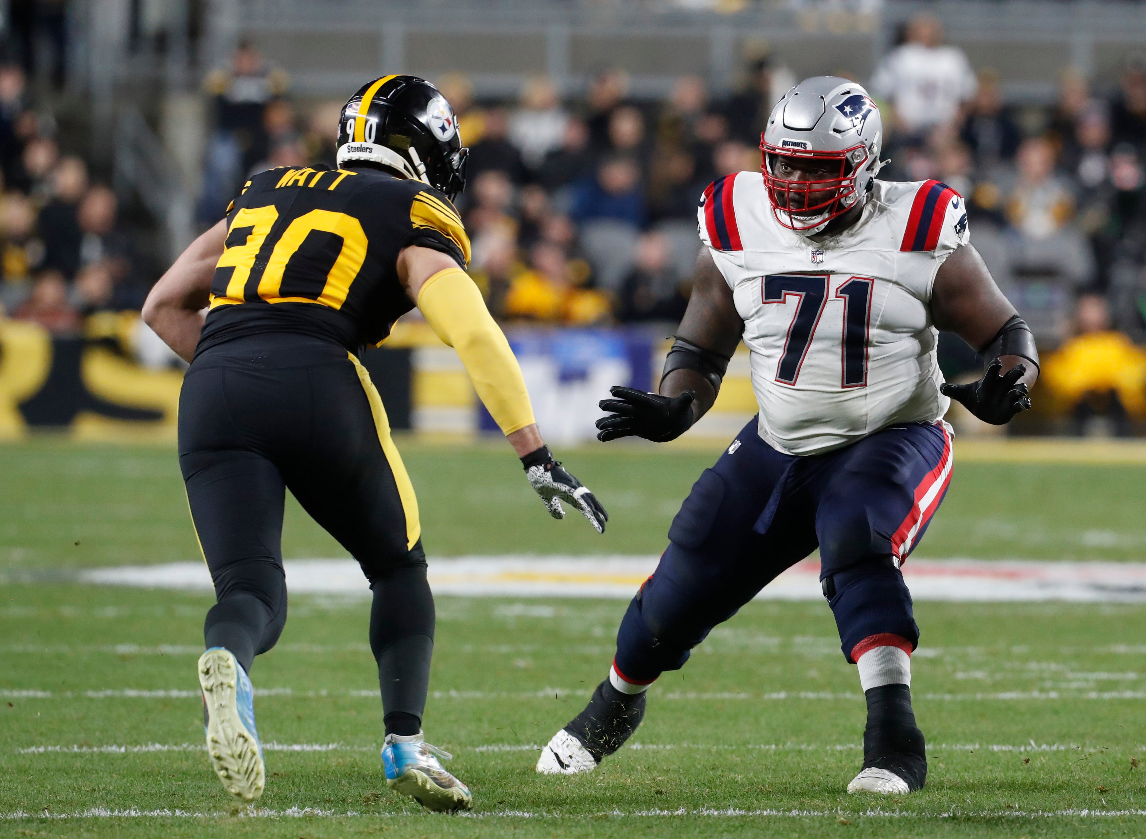Dec 7, 2023; Pittsburgh, Pennsylvania, USA; New England Patriots guard Mike Onwenu (71) blocks against Pittsburgh Steelers linebacker T.J. Watt (90) during the second quarter at Acrisure Stadium.