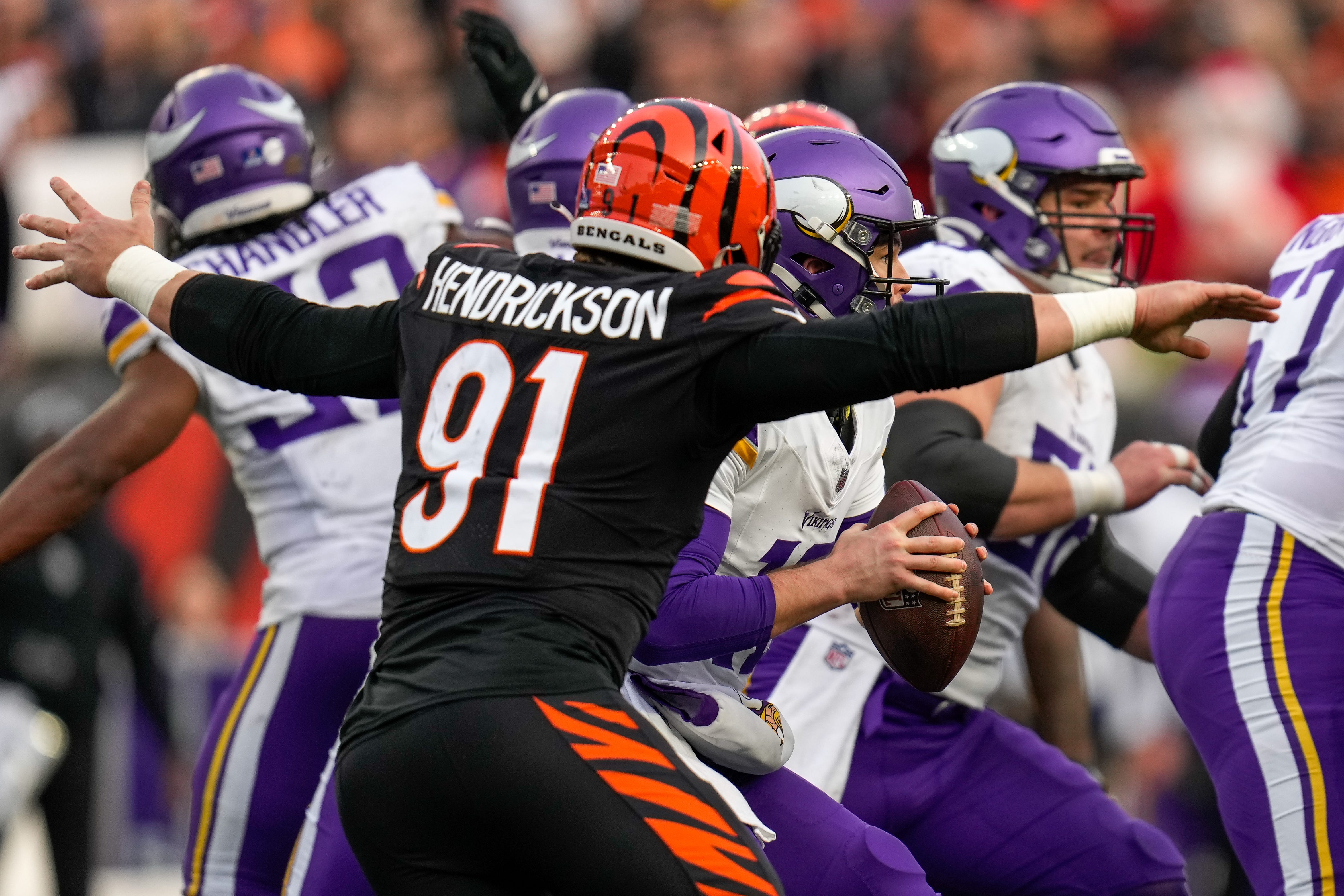 Cincinnati Bengals defensive end Trey Hendrickson (91) wraps up Minnesota Vikings quarterback Nick Mullens (12) for a loss in the fourth quarter of the NFL Week 15 game between the Cincinnati Bengals and the Minnesota Vikings at PayCor Stadium in downtown Cincinnati on Saturday, Dec. 16, 2023. The Bengals won on an overtime field goal.
