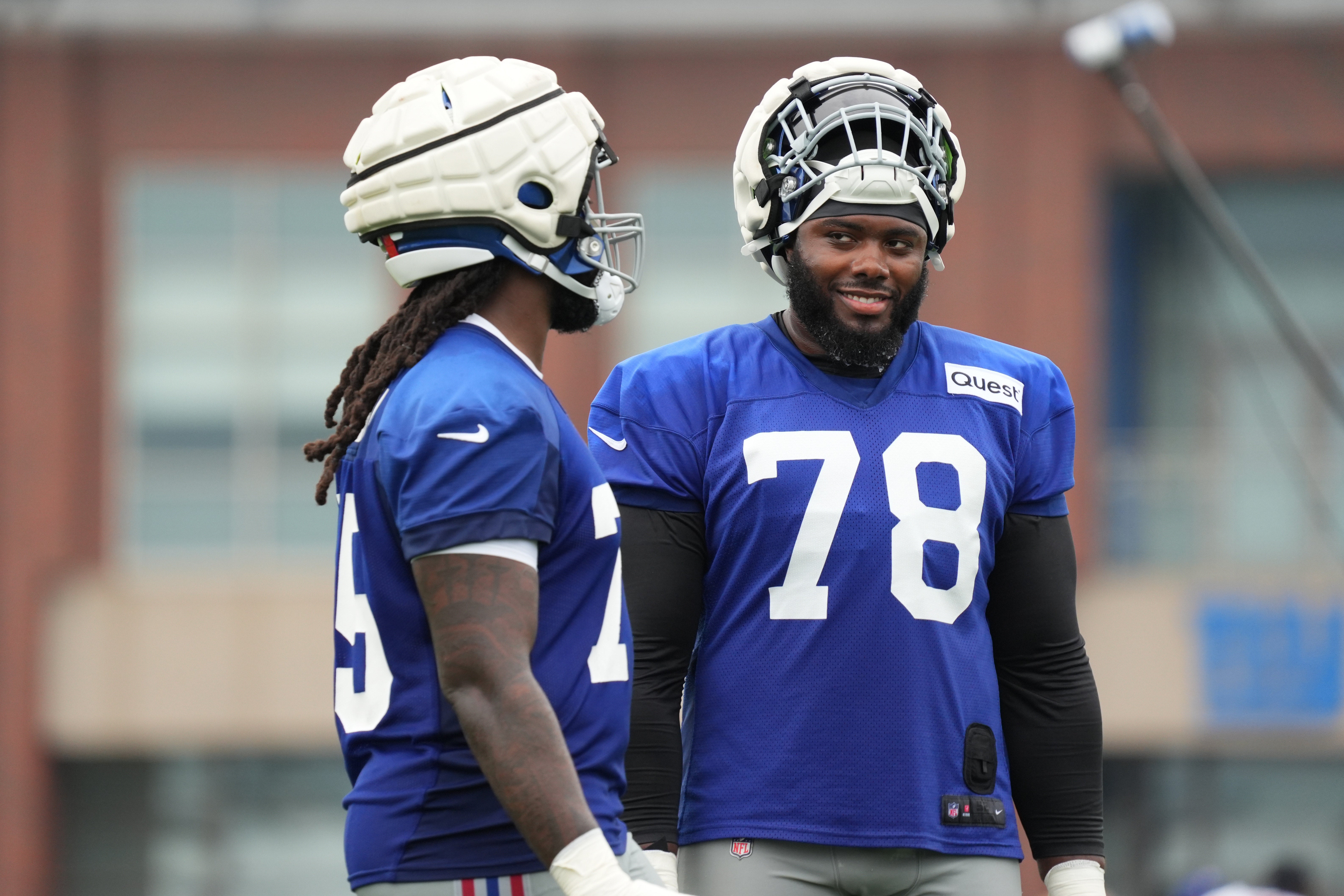 Jul 25, 2024; East Rutherford, NY, USA; New York Giants offensive tackle Joshua Ezeudu (75) takes a water break with offensive tackle Andrew Thomas (78) during training camp at Quest Diagnostics Training Center.