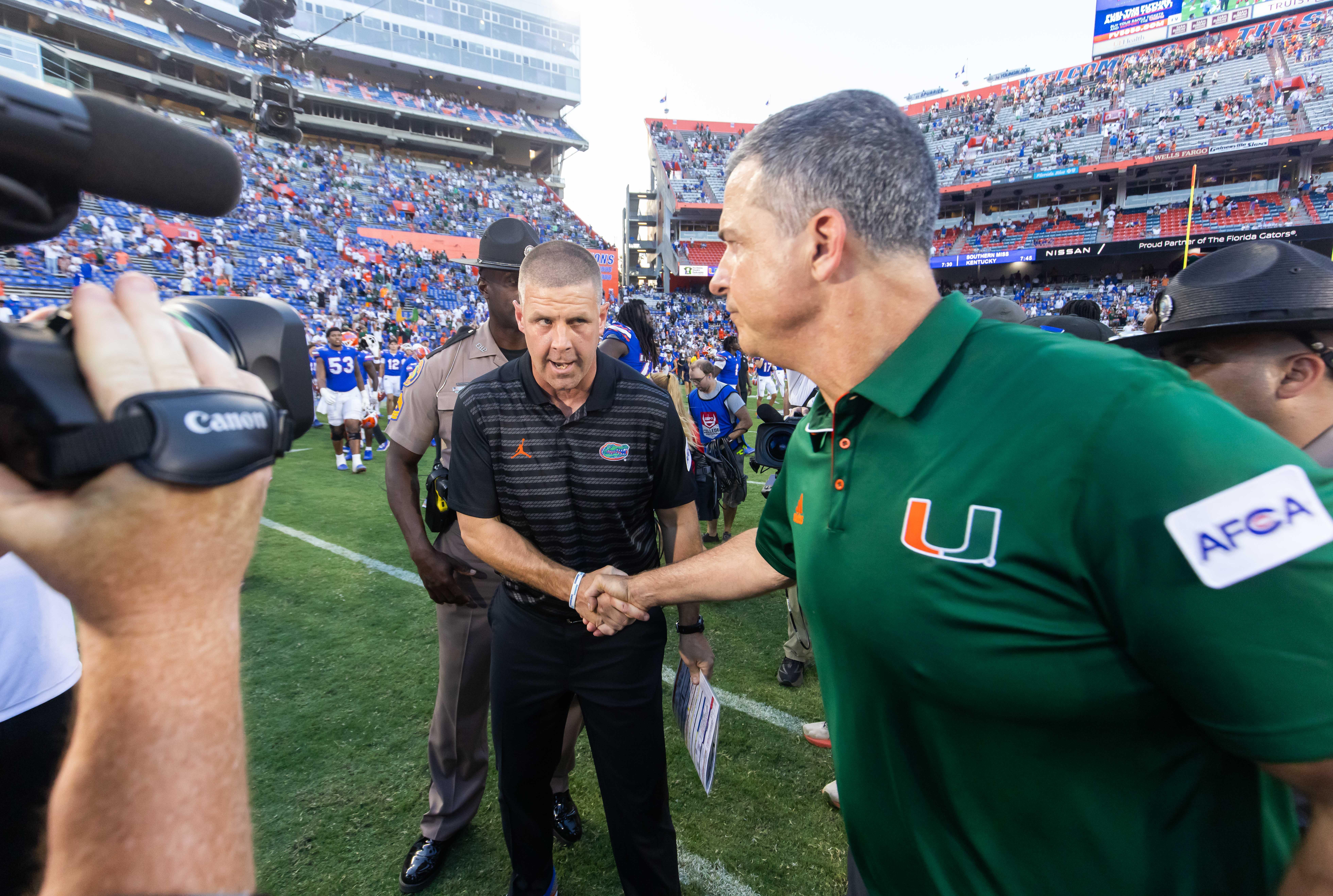 Florida Gators head coach Billy Napier, left shakes hands with Miami Hurricanes head coach Mario Cristobal after the Hurricanes defeated the Gators during the season opener at Ben Hill Griffin Stadium in Gainesville, FL on Saturday, August 31, 2024 against the University of Miami Hurricanes. The Hurricanes defeated the Gators 41-17.