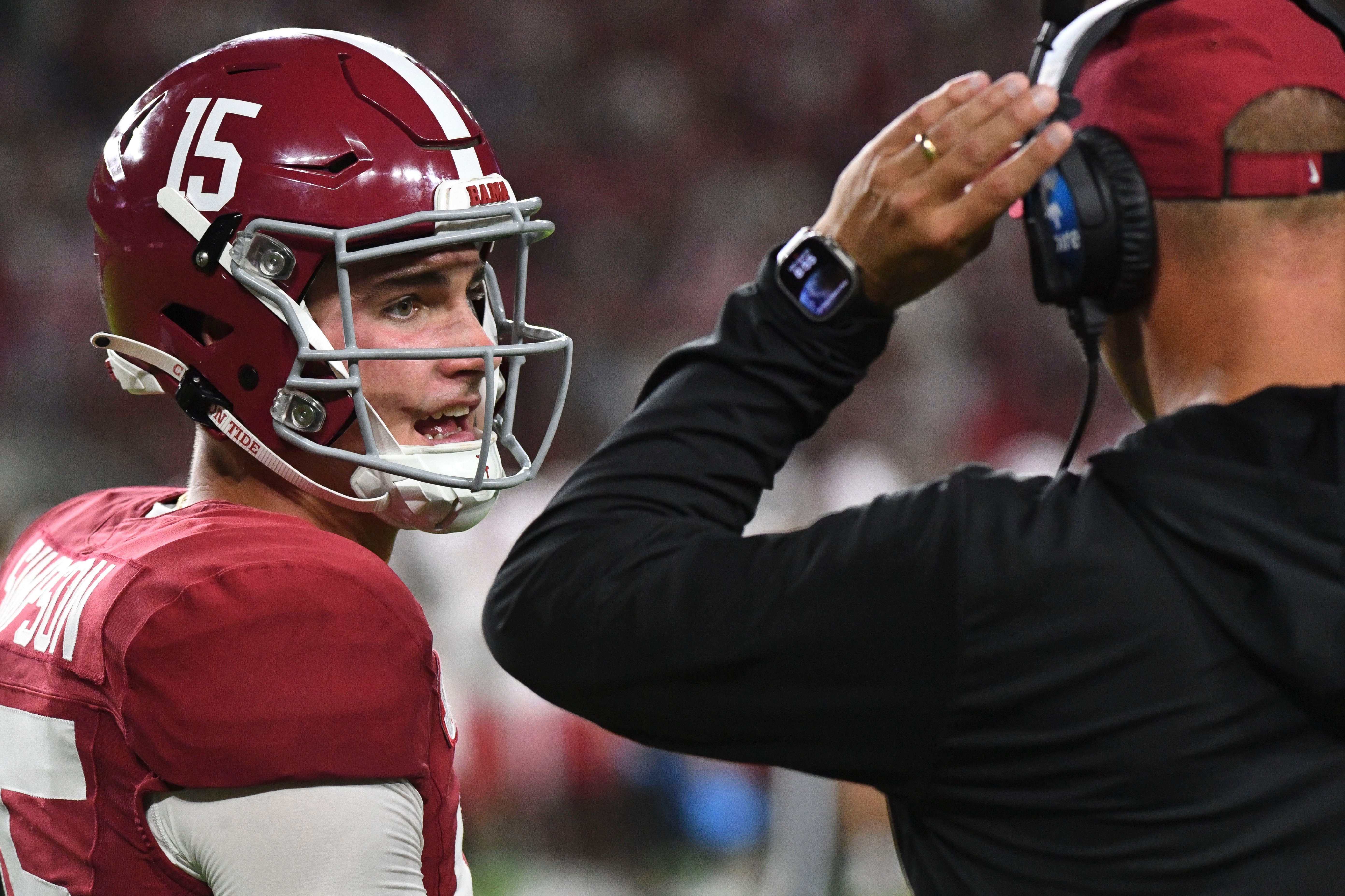 Aug 31, 2024; Tuscaloosa, Alabama, USA; Alabama Crimson Tide quarterback Ty Simpson (15) talks with Alabama Crimson Tide head coach Kalen DeBoer at Bryant-Denny Stadium during the game between the Alabama Crimson Tide and the Western Kentucky Hilltoppers. Alabama defeated Western Kentucky 63-0.