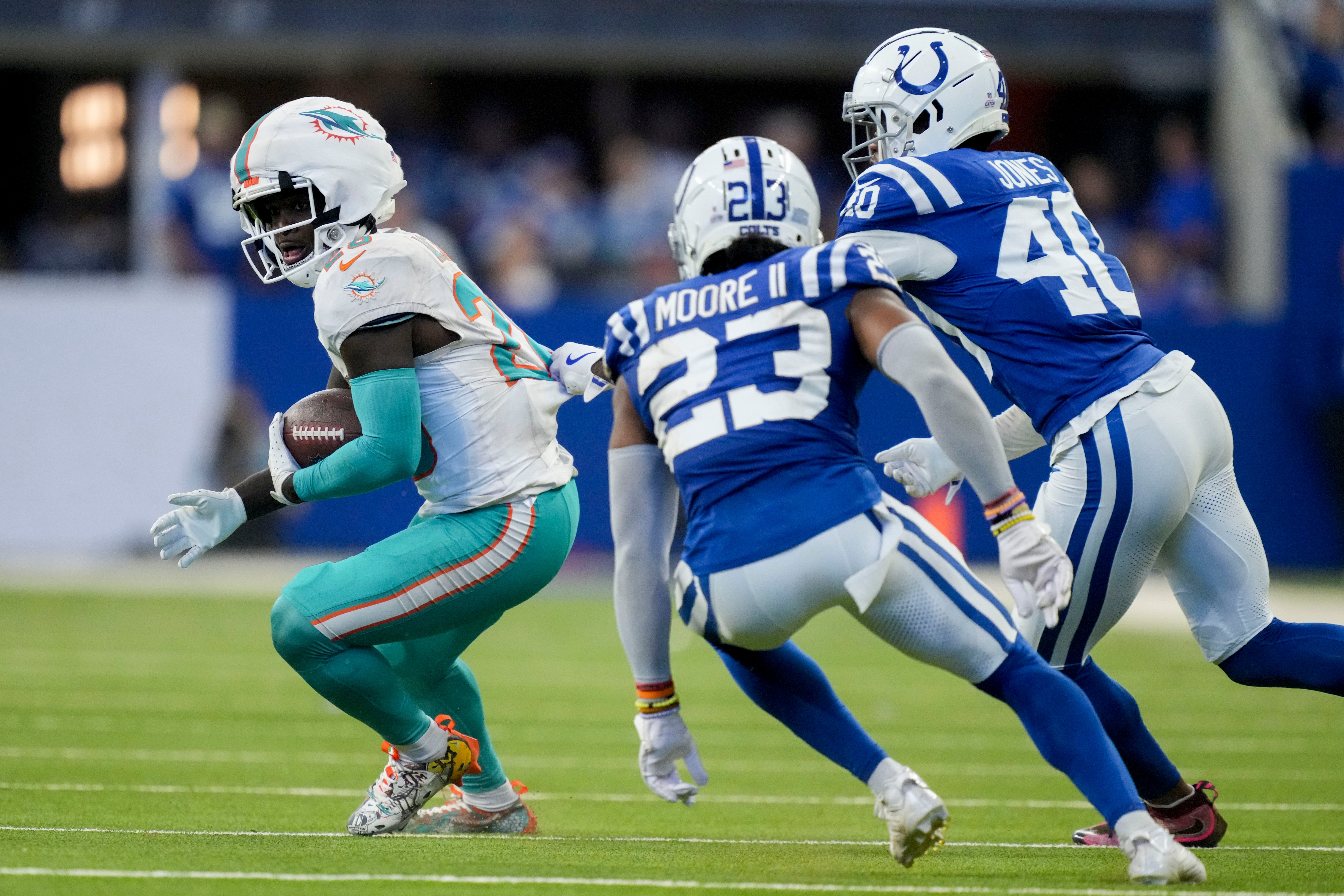 Dolphins RB De'Von Achane tries to make a move vs. Colts CB Kenny Moore