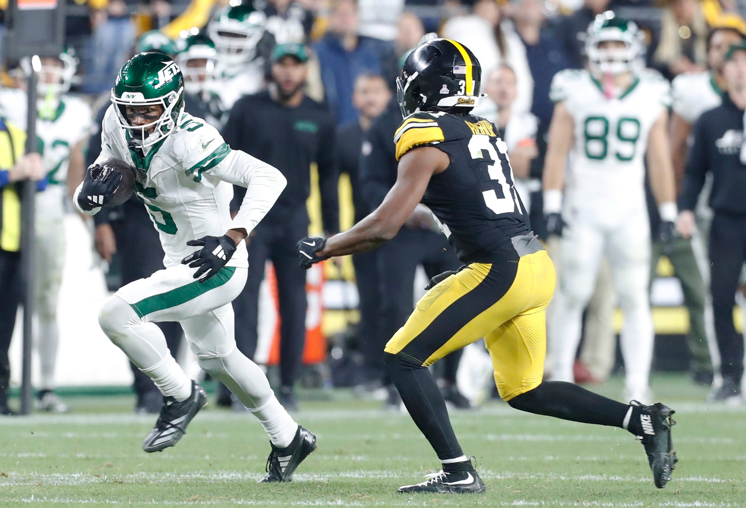 Oct 20, 2024; Pittsburgh, Pennsylvania, USA; New York Jets wide receiver Garrett Wilson (5) runs after a catch against the Pittsburgh Steelers during the fourth quarter at Acrisure Stadium.