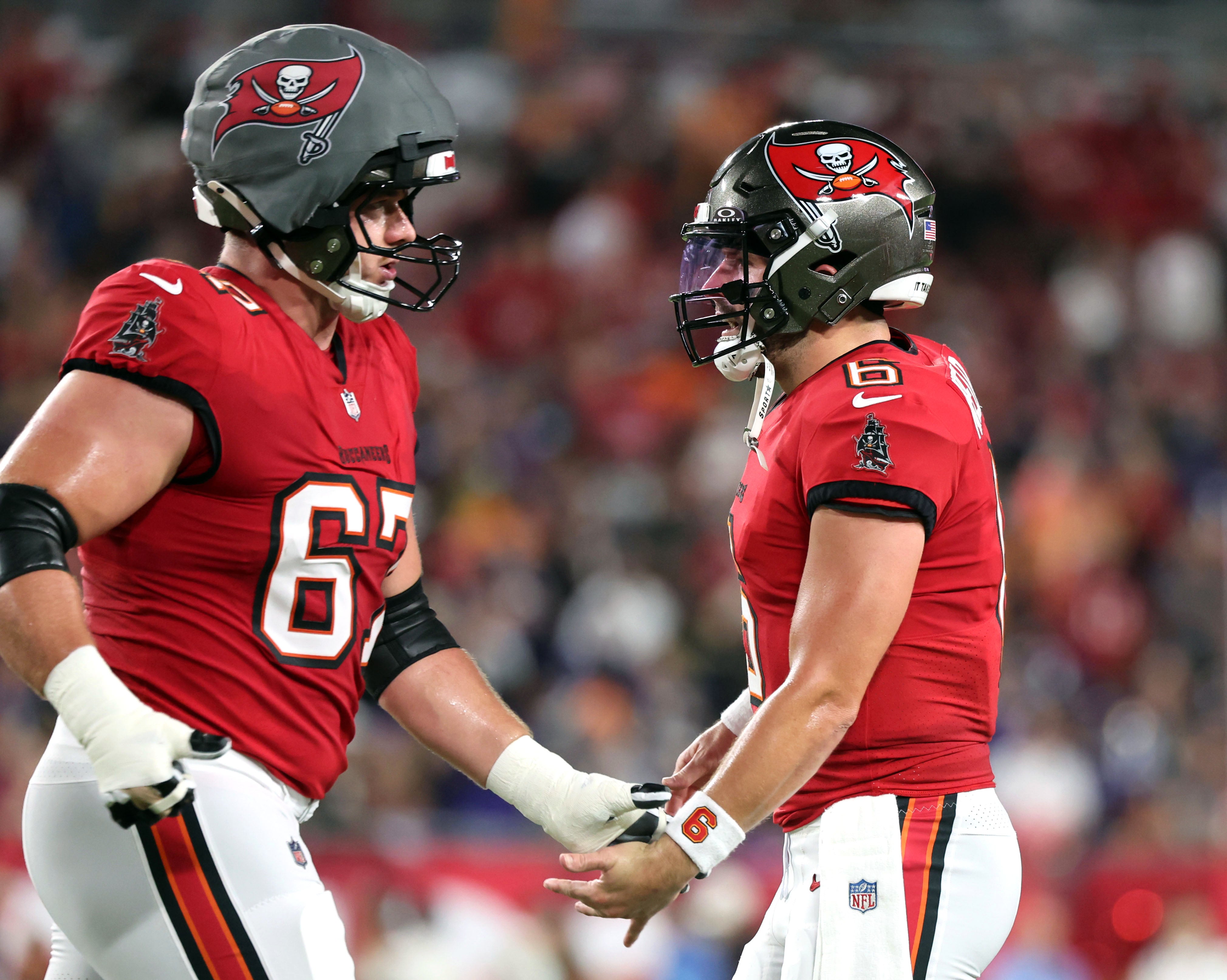 Oct 21, 2024; Tampa, Florida, USA; Tampa Bay Buccaneers quarterback Baker Mayfield (6) and offensive tackle Luke Goedeke (67) react after scoring a touchdown against the Baltimore Ravens during the first quarter at Raymond James Stadium.