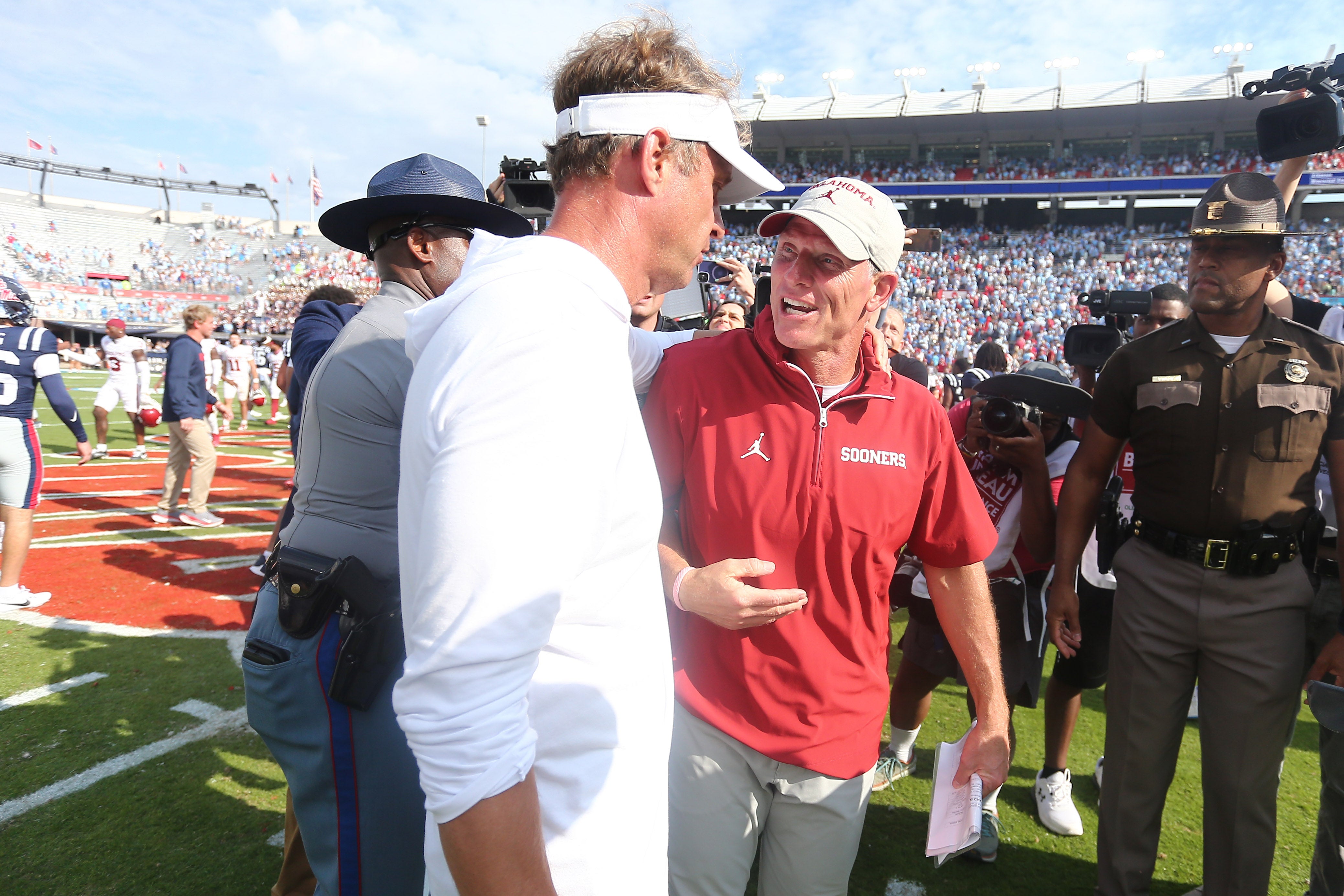 Oct 26, 2024; Oxford, Mississippi, USA; Oklahoma Sooners head coach Brent Venables (right) and Mississippi Rebels head coach Lane Kiffin talk after the game at Vaught-Hemingway Stadium.