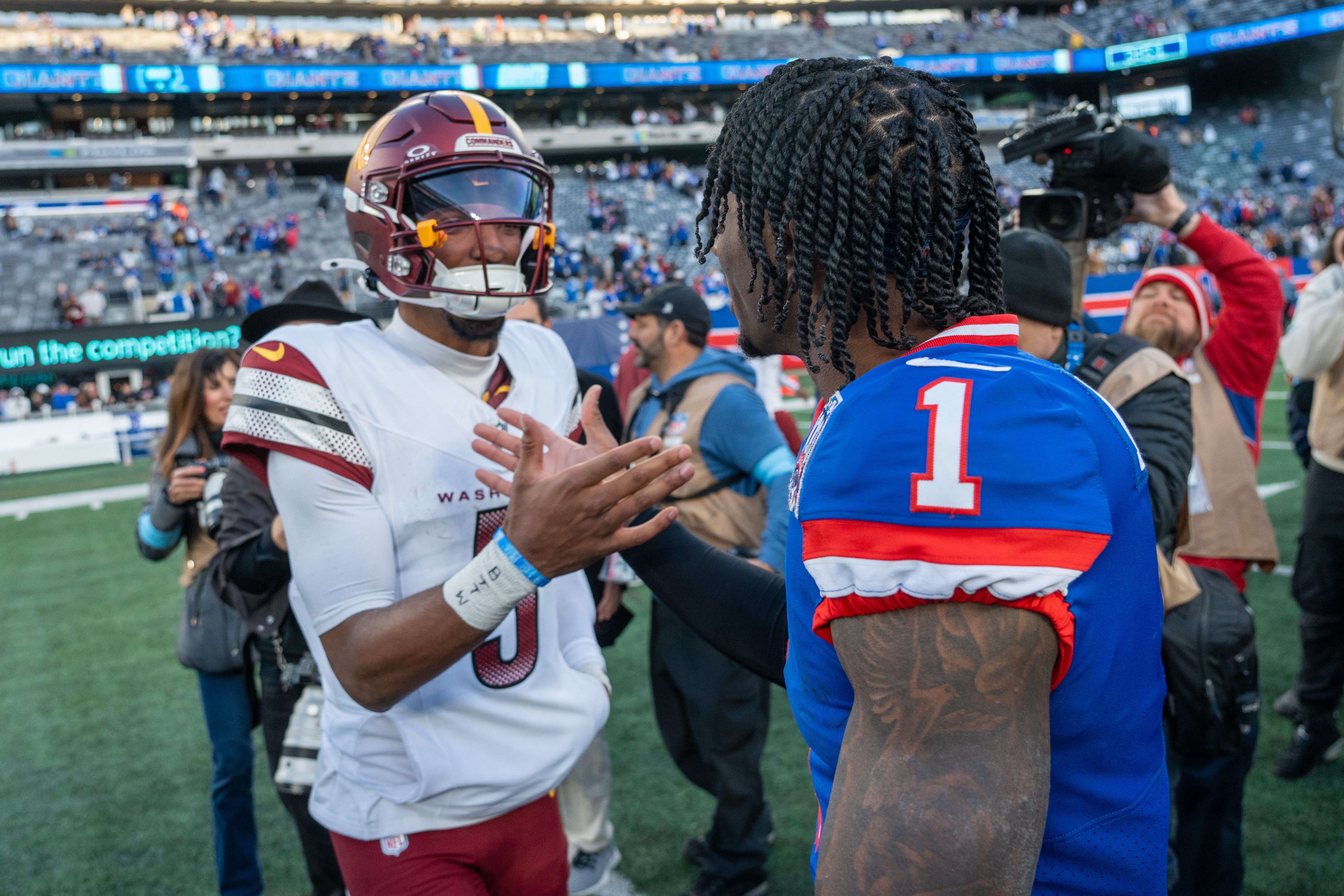 Washington Commanders quarterback Jayden Daniels (5) shakes hands with New York Giants wide receiver Malik Nabers (1) after a game between the New York Giants and the Washington Commanders at MetLife Stadium in East Rutherford on Sunday, Nov. 3, 2024.
