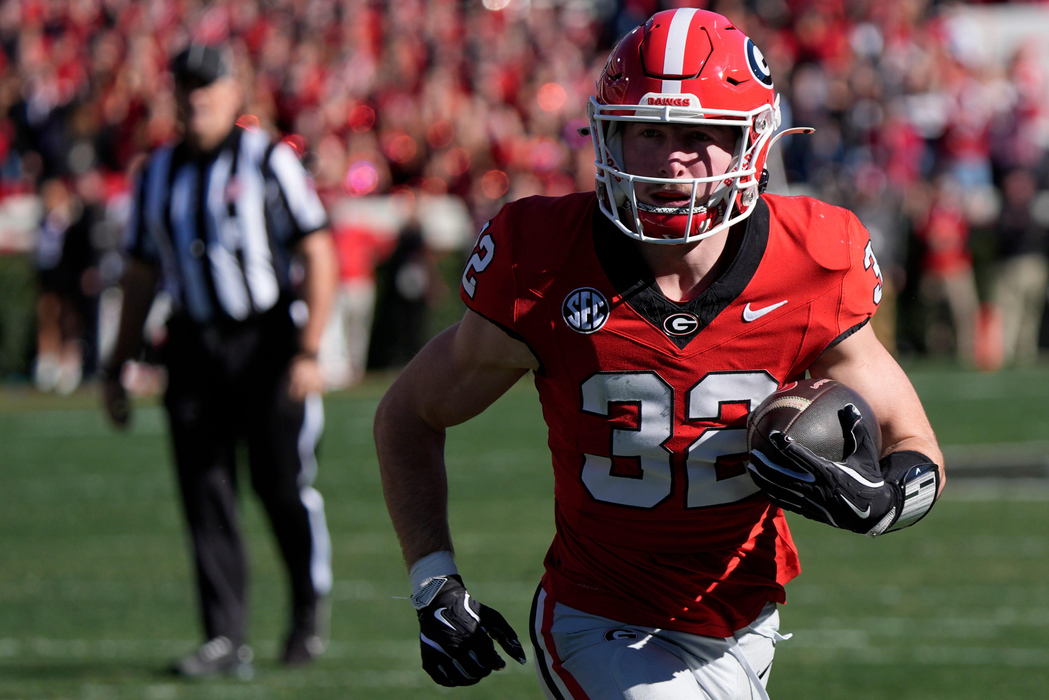 Georgia running back Cash Jones (32) drives in for a touchdown during the first half of a NCAA college football game against Massachusetts in Athens, Ga., on Saturday, Nov. 23, 2024.
