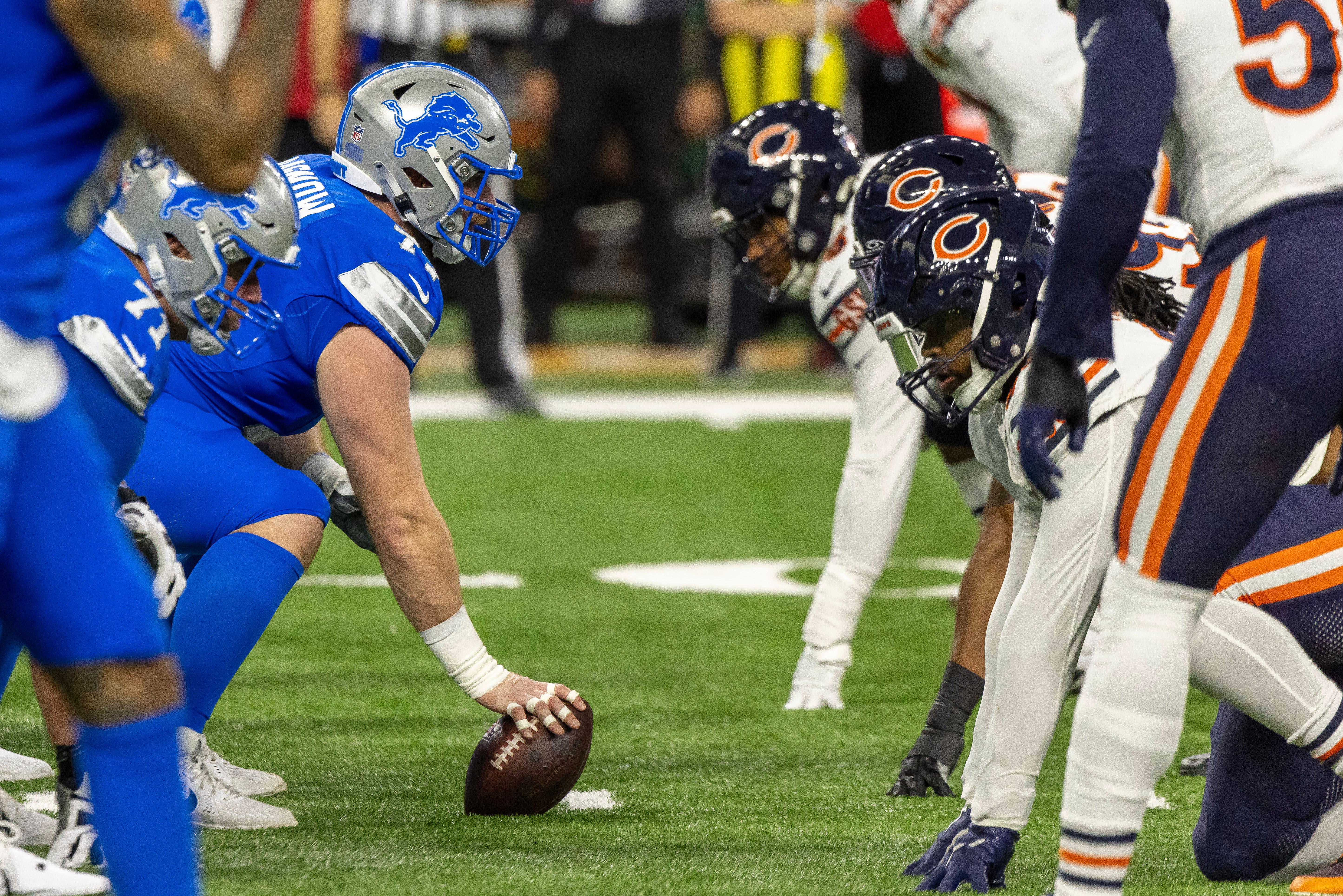 Nov 28, 2024; Detroit, Michigan, USA; Detroit Lions center Frank Ragnow (77) gets set to hike the ball against the Chicago Bears during the first half at Ford Field.