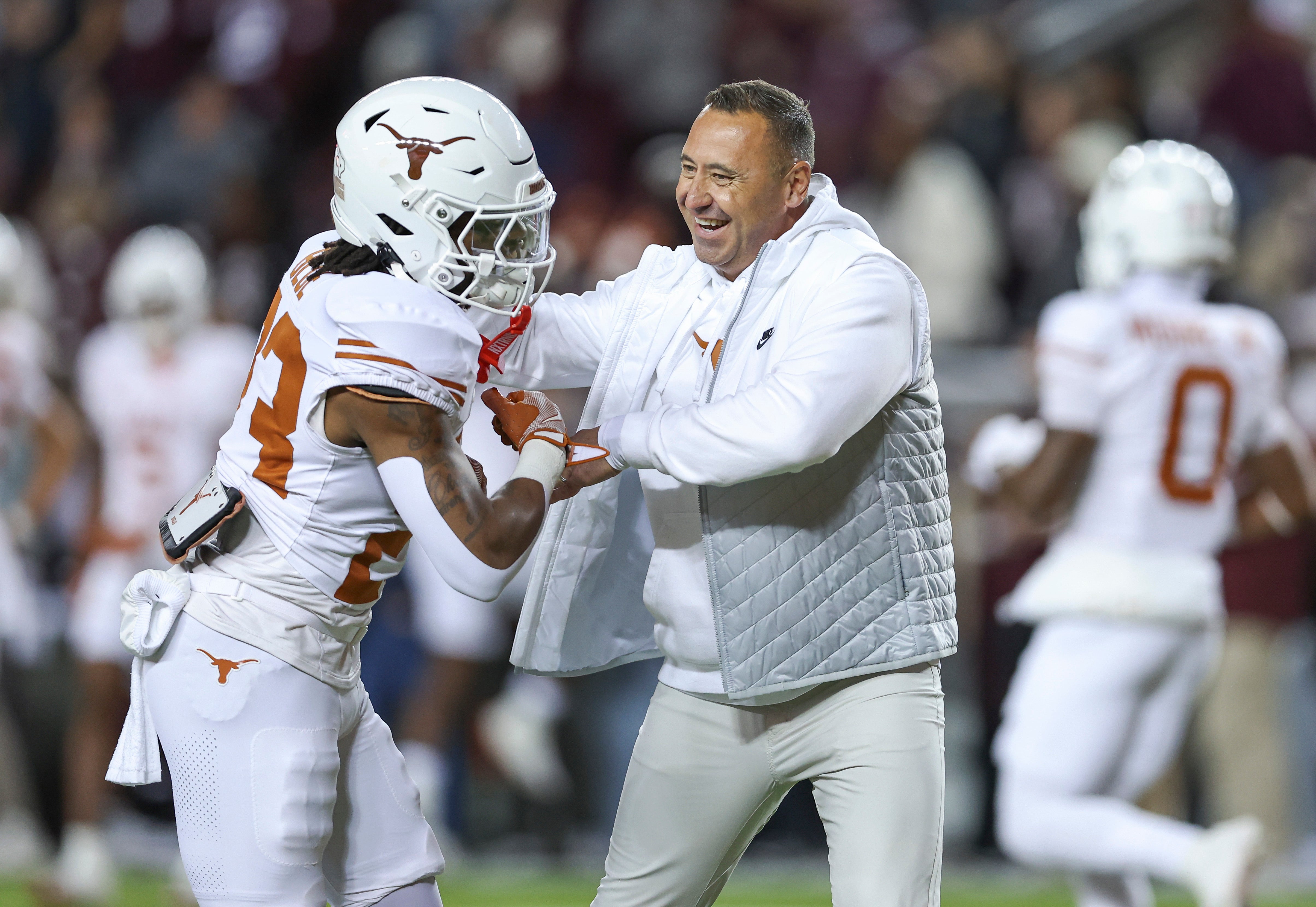 Nov 30, 2024; College Station, Texas, USA; Texas Longhorns head coach Steve Sarkisian smiles with running back Jaydon Blue (23) before the game against the Texas A&M Aggies at Kyle Field.