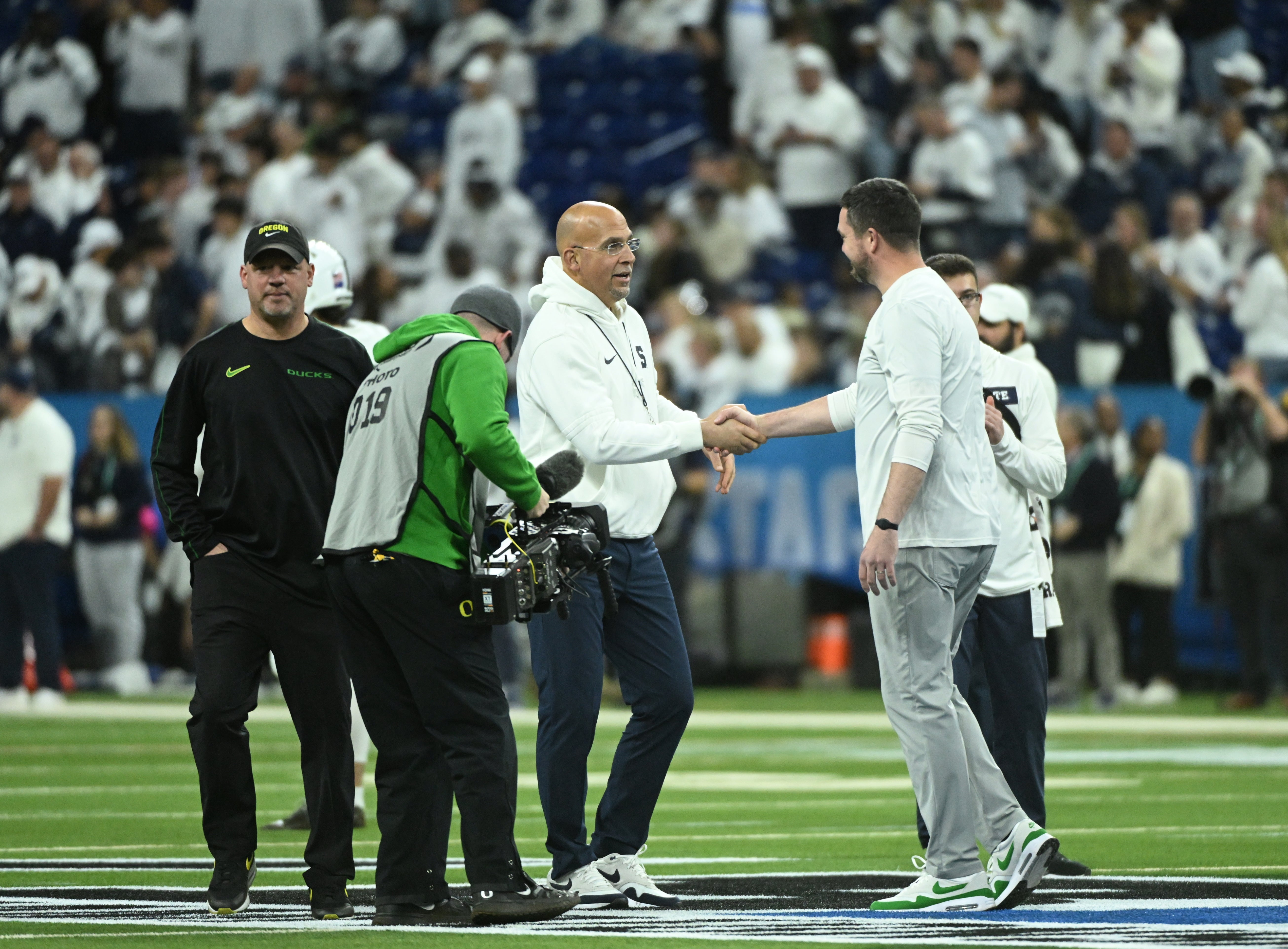 Dec 7, 2024; Indianapolis, IN, USA; Penn State Nittany Lions head coach James Franklin shakes hands with Oregon Ducks head coach Dan Lanning in the 2024 Big Ten Championship game at Lucas Oil Stadium. Mandatory Credit: Robert Goddin-Imagn Images