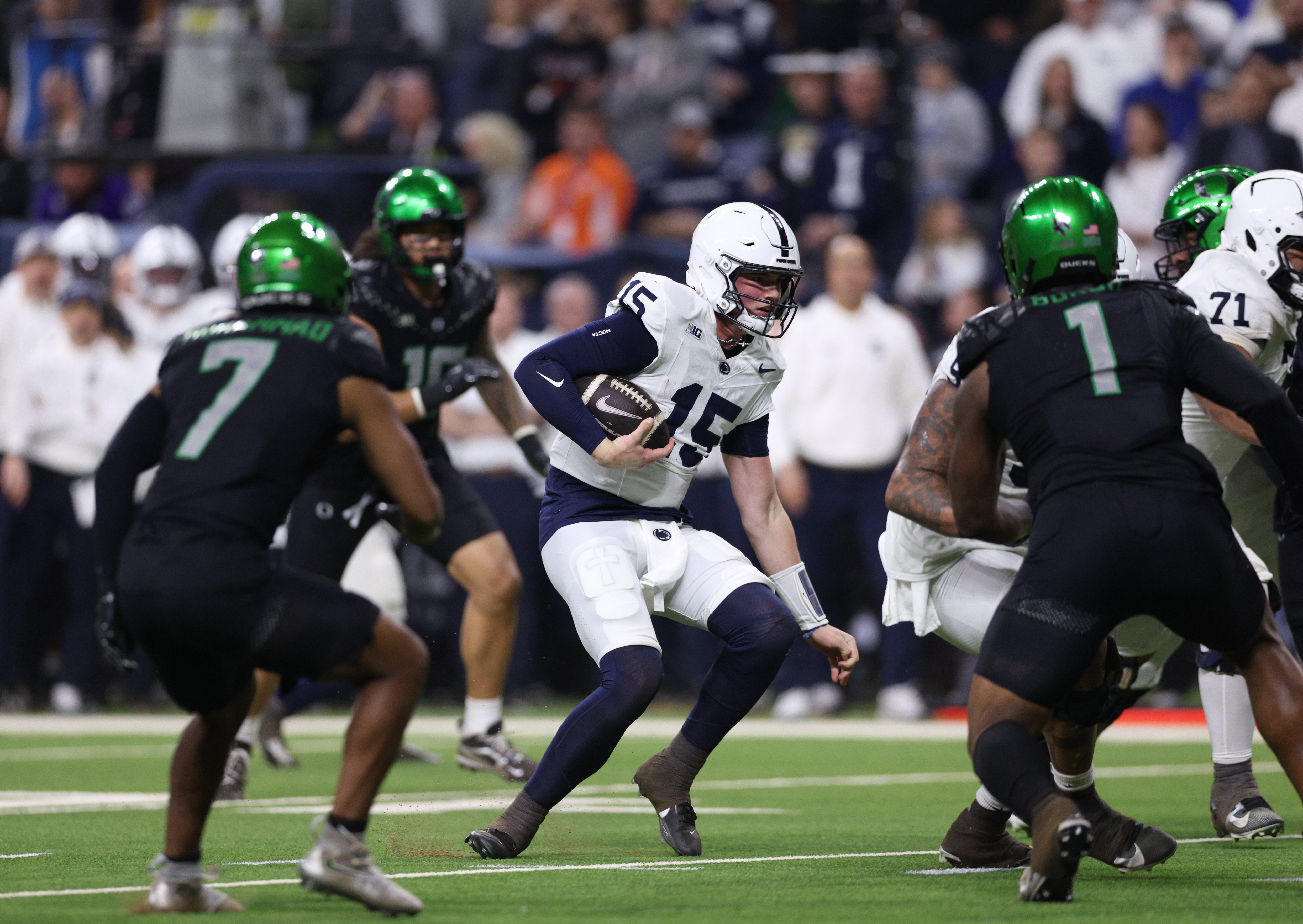 Dec 7, 2024; Indianapolis, IN, USA; Penn State Nittany Lions quarterback Drew Allar (15) runs for a gain against the Oregon Ducks during the second quarter in the 2024 Big Ten Championship game at Lucas Oil Stadium.