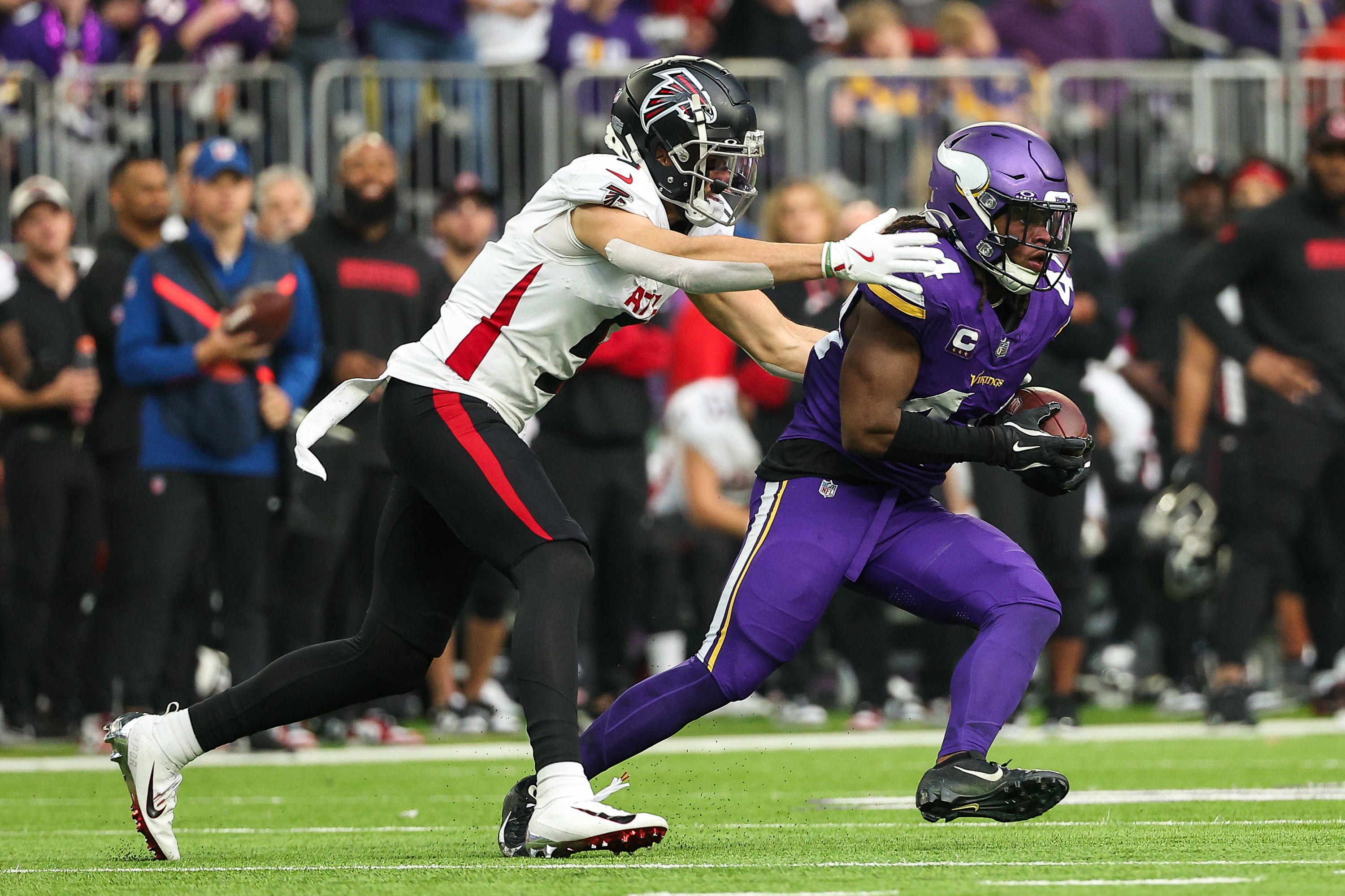 Dec 8, 2024; Minneapolis, Minnesota, USA; Minnesota Vikings safety Josh Metellus (44) intercepts a pass intended for Atlanta Falcons wide receiver Drake London (5) during the second quarter at U.S. Bank Stadium.