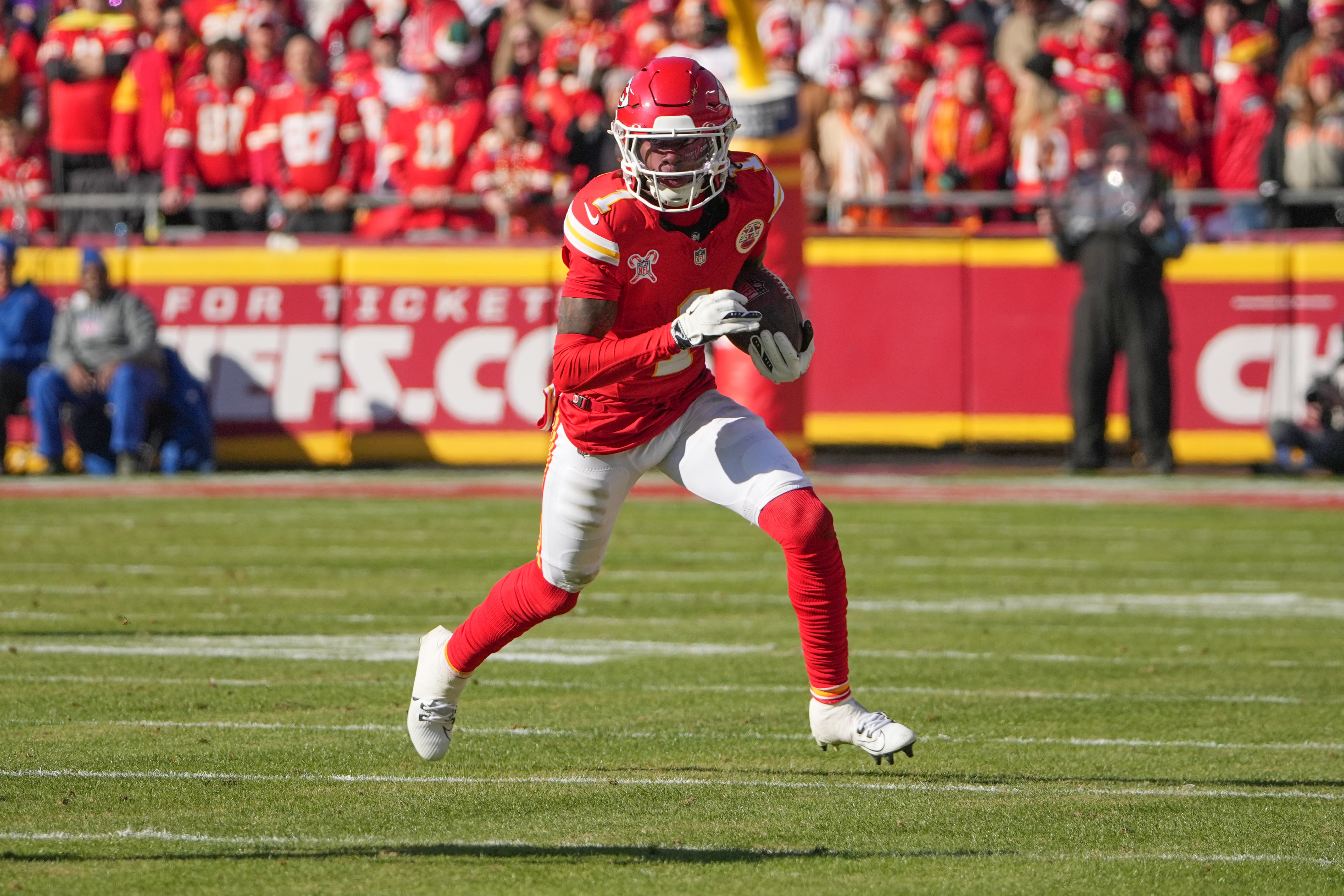 Kansas City Chiefs wide receiver Xavier Worthy (1) runs the ball against the Houston Texans during the first half at GEHA Field at Arrowhead Stadium.