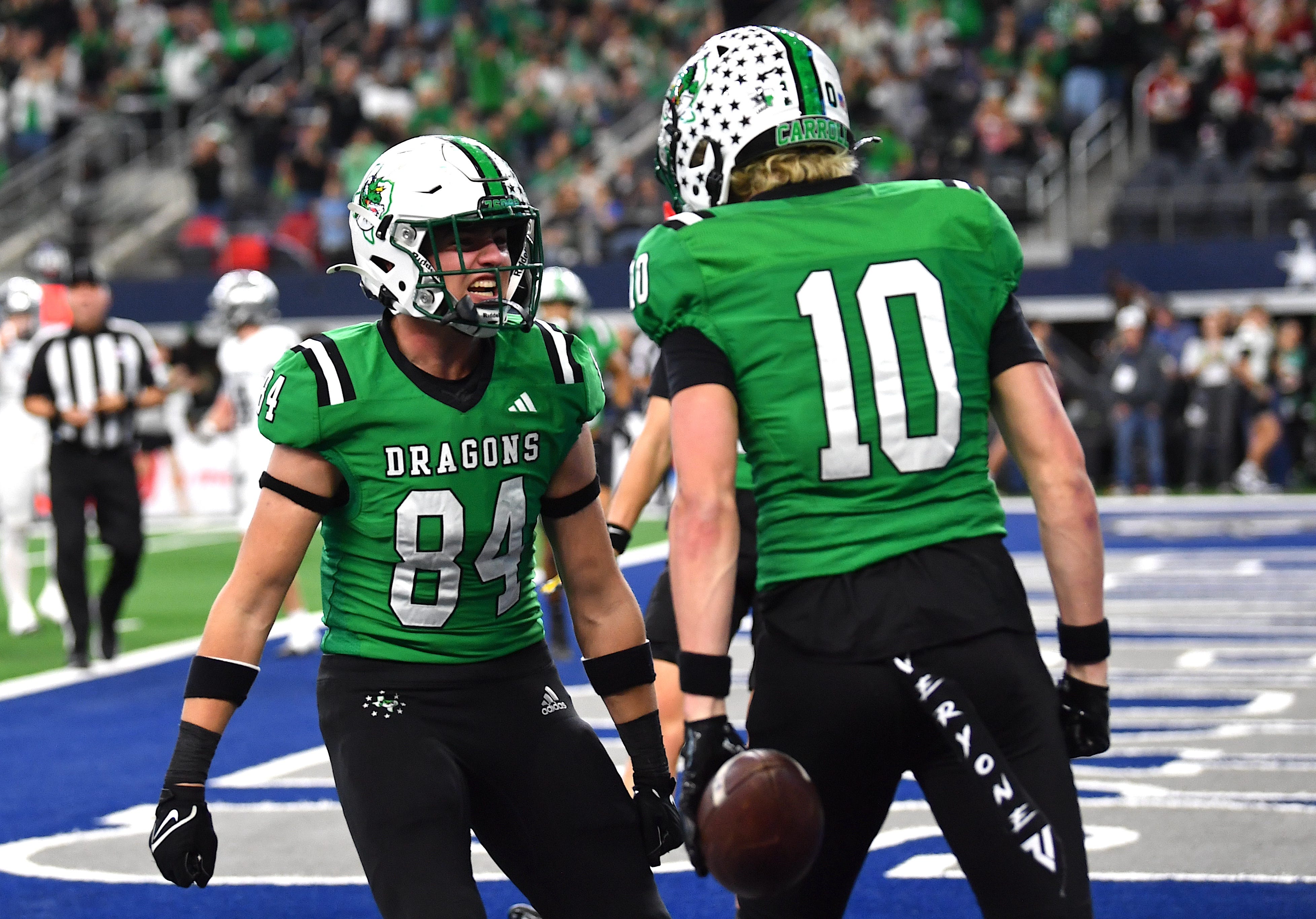 Southlake Carroll's Brody Knowles (10) celebrates with John Mark Fraga (84) in the end zone during the 6A DII UIL Texas State Football Championship game on Saturday, December 21, 2024 at AT&T Stadium in Arlington.