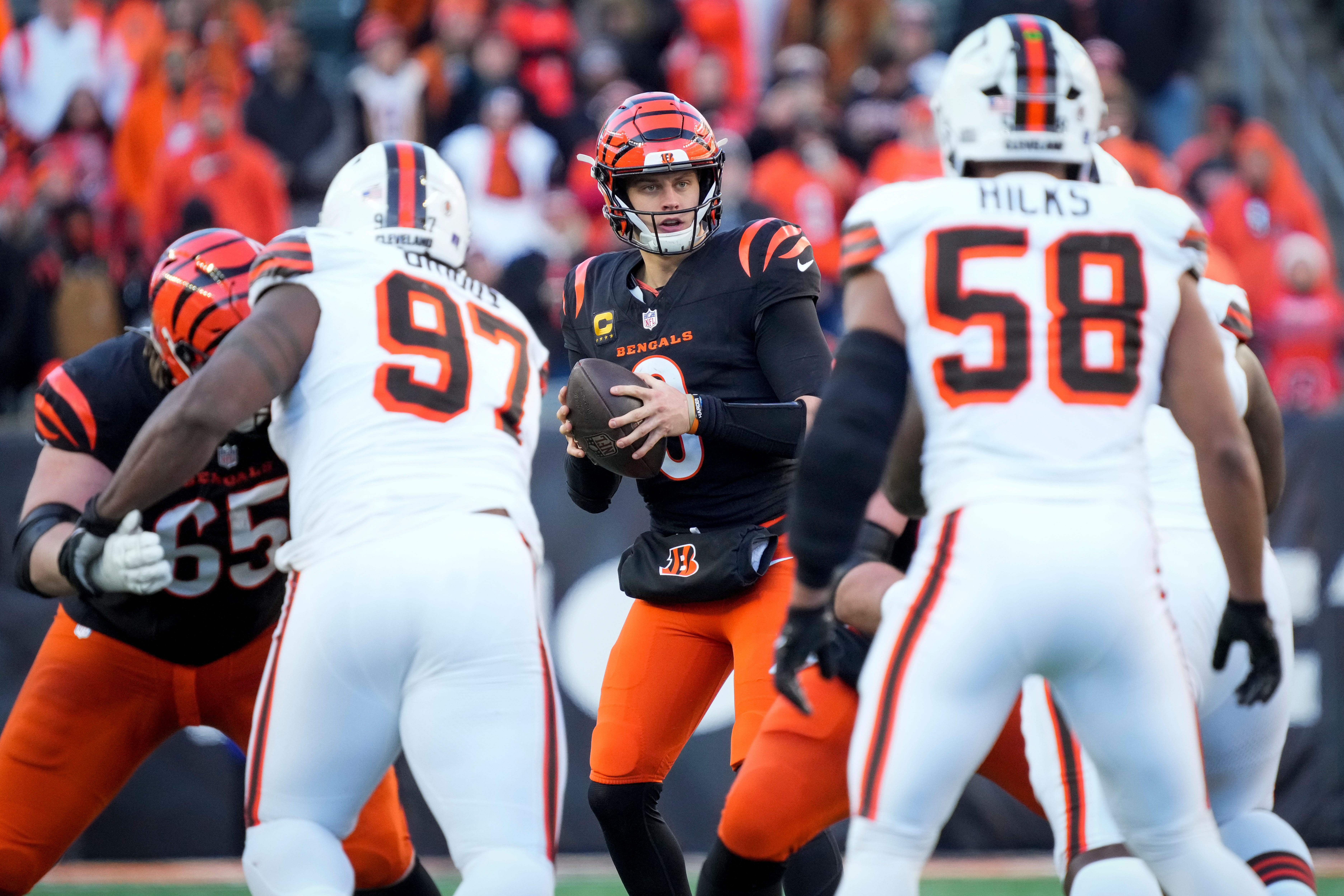 Cincinnati Bengals quarterback Joe Burrow (9) takes a snap before throwing a touchdown pass to Ja'Marr Chase in the fourth quarter of the NFL Week 16 game between the Cincinnati Bengals and the Cleveland Browns at Paycor Stadium in downtown Cincinnati on Sunday, Dec. 22, 2024. The Bengals won 24-16.