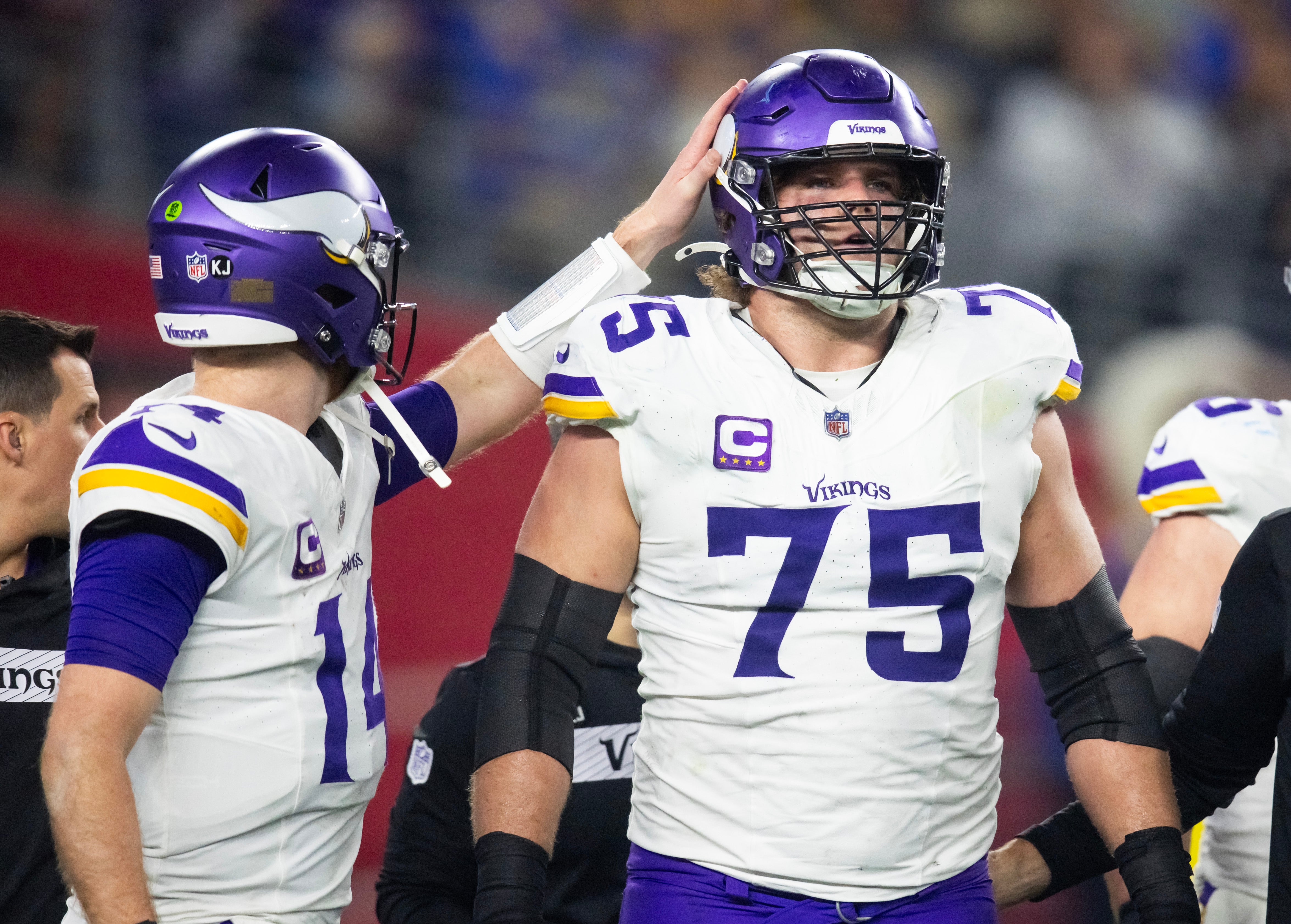 Jan 13, 2025; Glendale, AZ, USA; Minnesota Vikings quarterback Sam Darnold (14) and tackle Brian O'Neill (75) against the Los Angeles Rams during an NFC wild card game at State Farm Stadium.