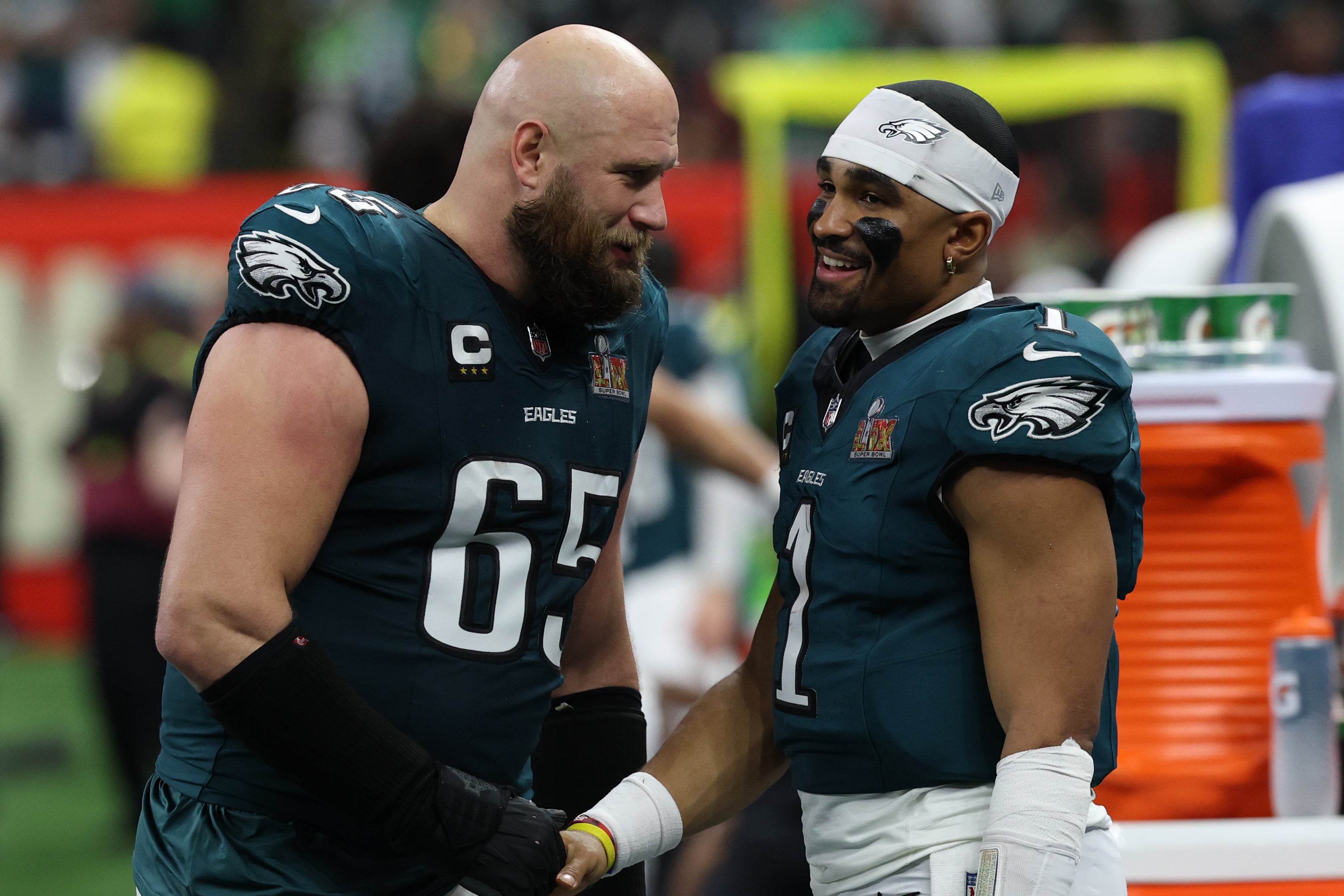 Philadelphia Eagles quarterback Jalen Hurts (1) celebrates with Eagles offensive tackle Lane Johnson (65) on the bench during the fourth quarter of Super Bowl LIX against the Kansas City Chiefs