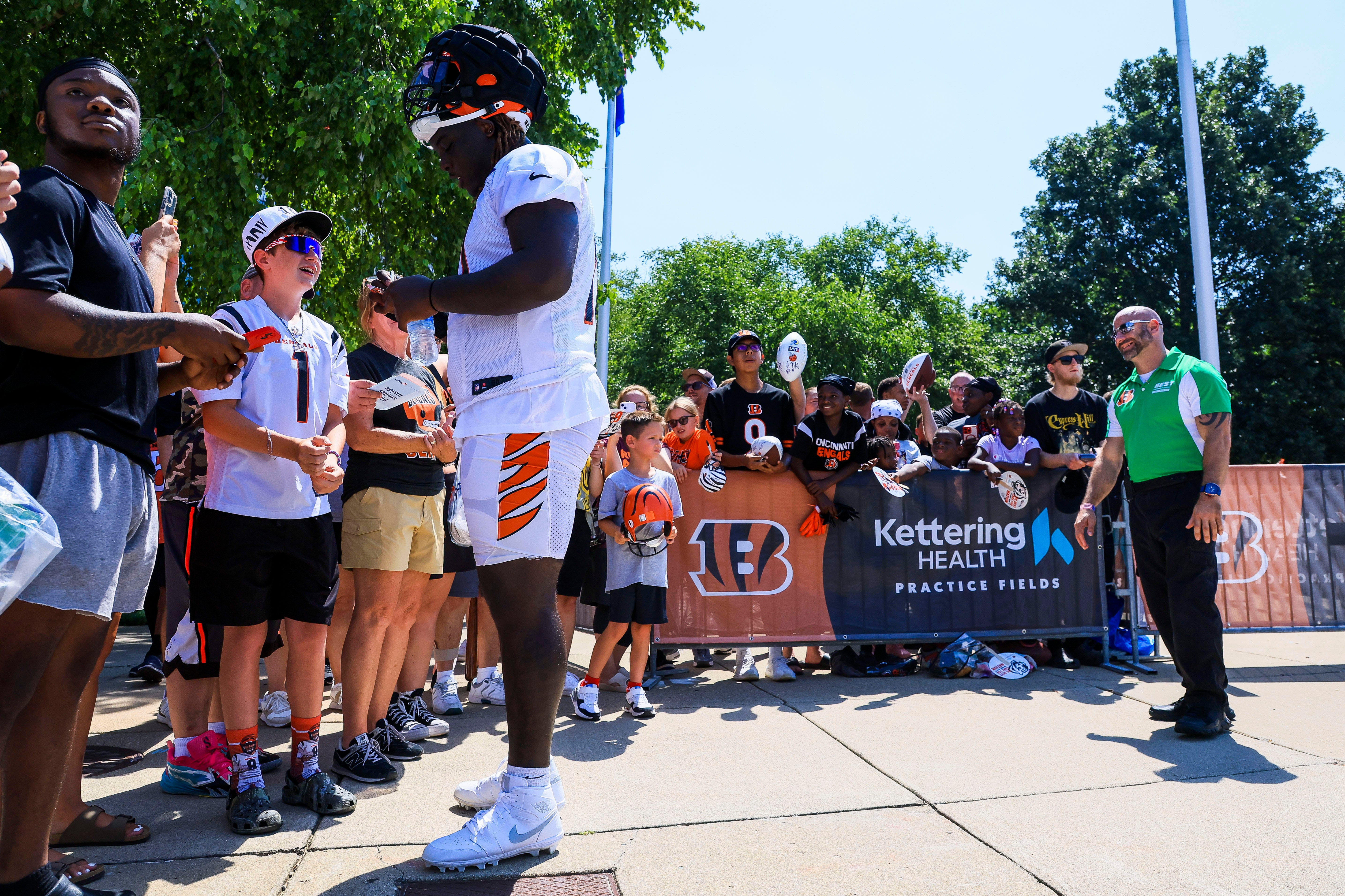 Jul 23, 2025; Cincinnati, OH, USA; Cincinnati Bengals offensive tackle Amarius Mims (71) signs autographs during training camp at Kettering Health Practice Field.