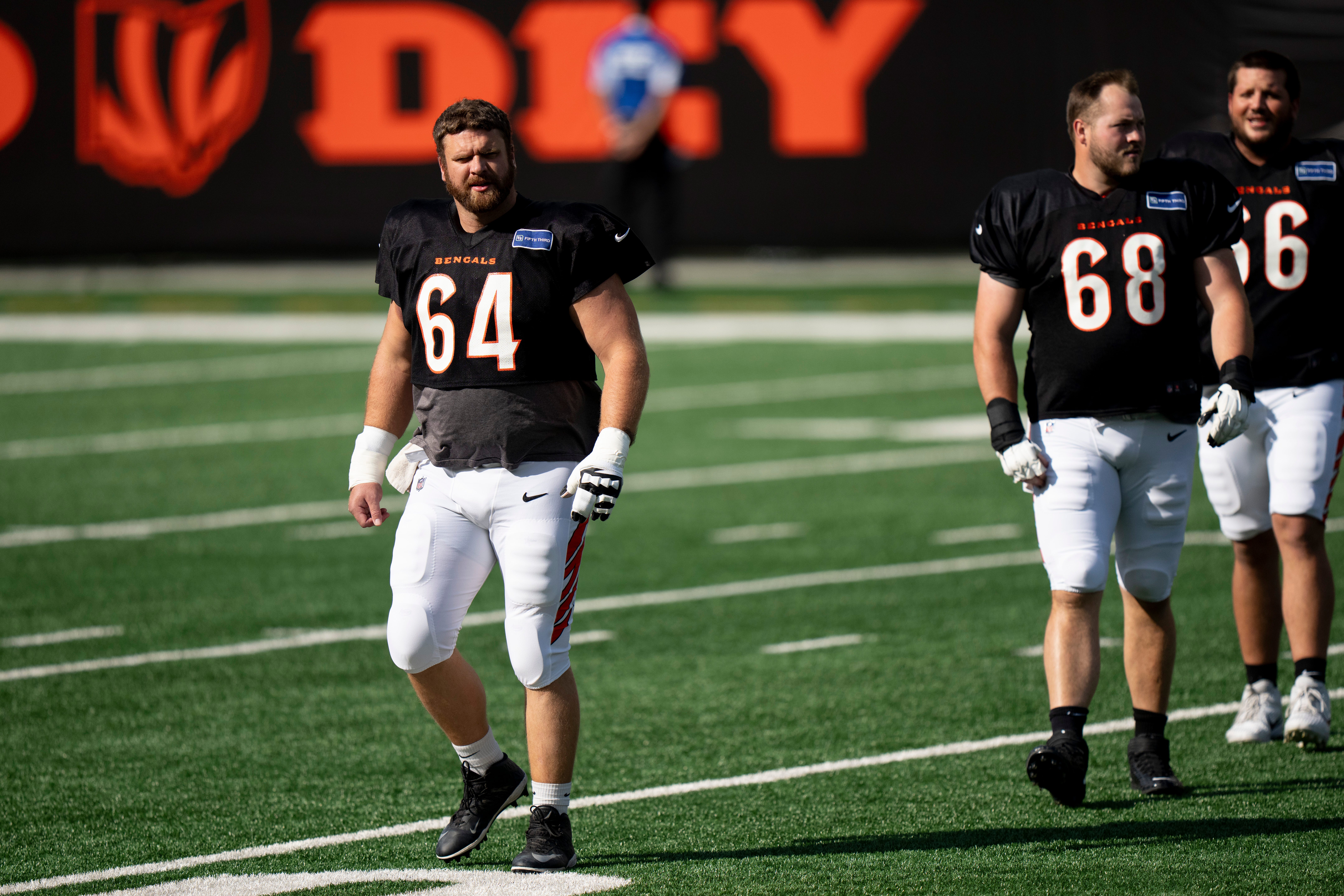 Cincinnati Bengals center Ted Karras (64) walks on the field during Bengals Camp practice at Paycor Stadium in Cincinnati on Aug. 2, 2025.