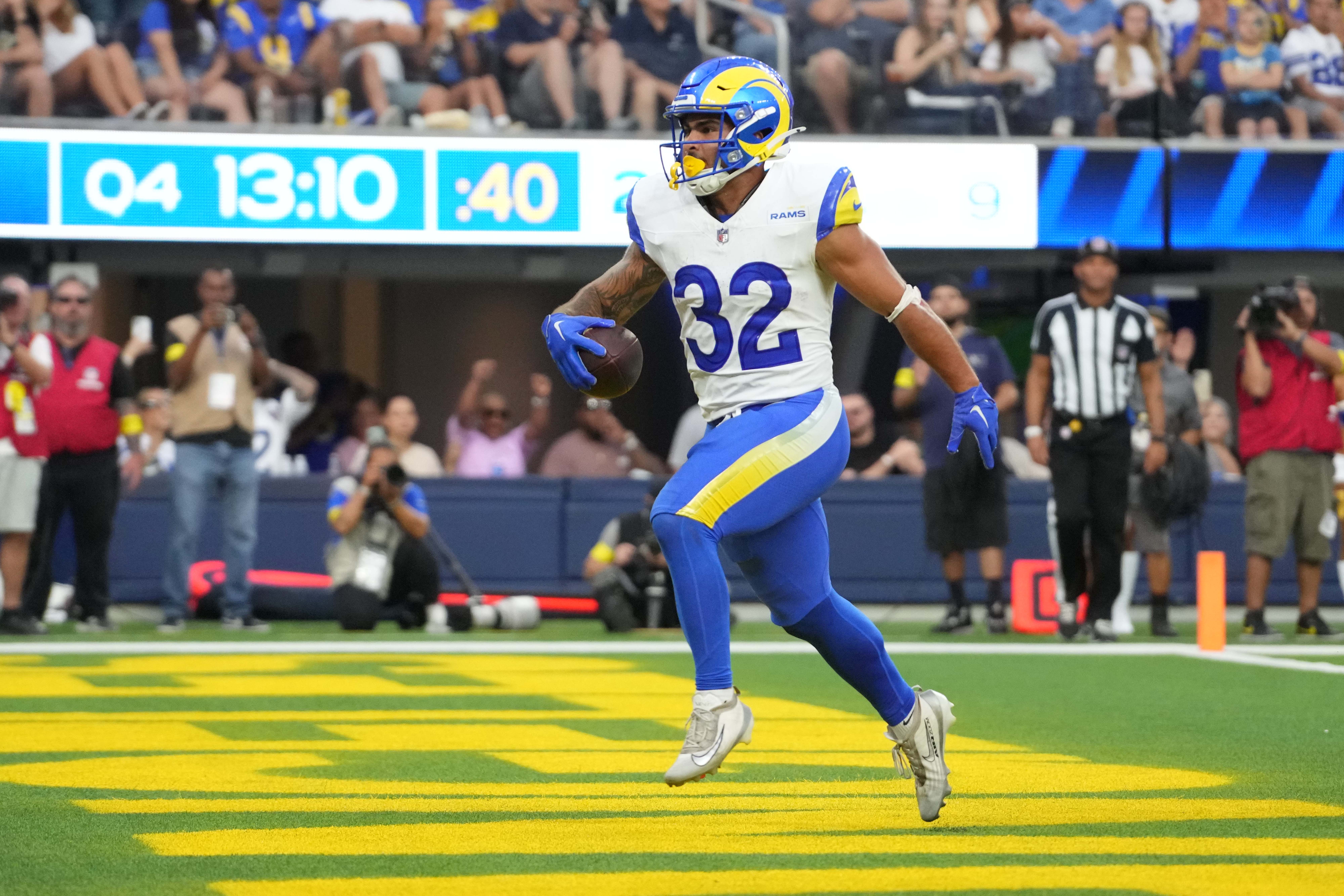 Aug 9, 2025; Inglewood, California, USA; Los Angeles Rams running back Cody Schrader (32) scores on a 9-yard touchdown reception in the fourth quarter against the Dallas Cowboys at SoFi Stadium.