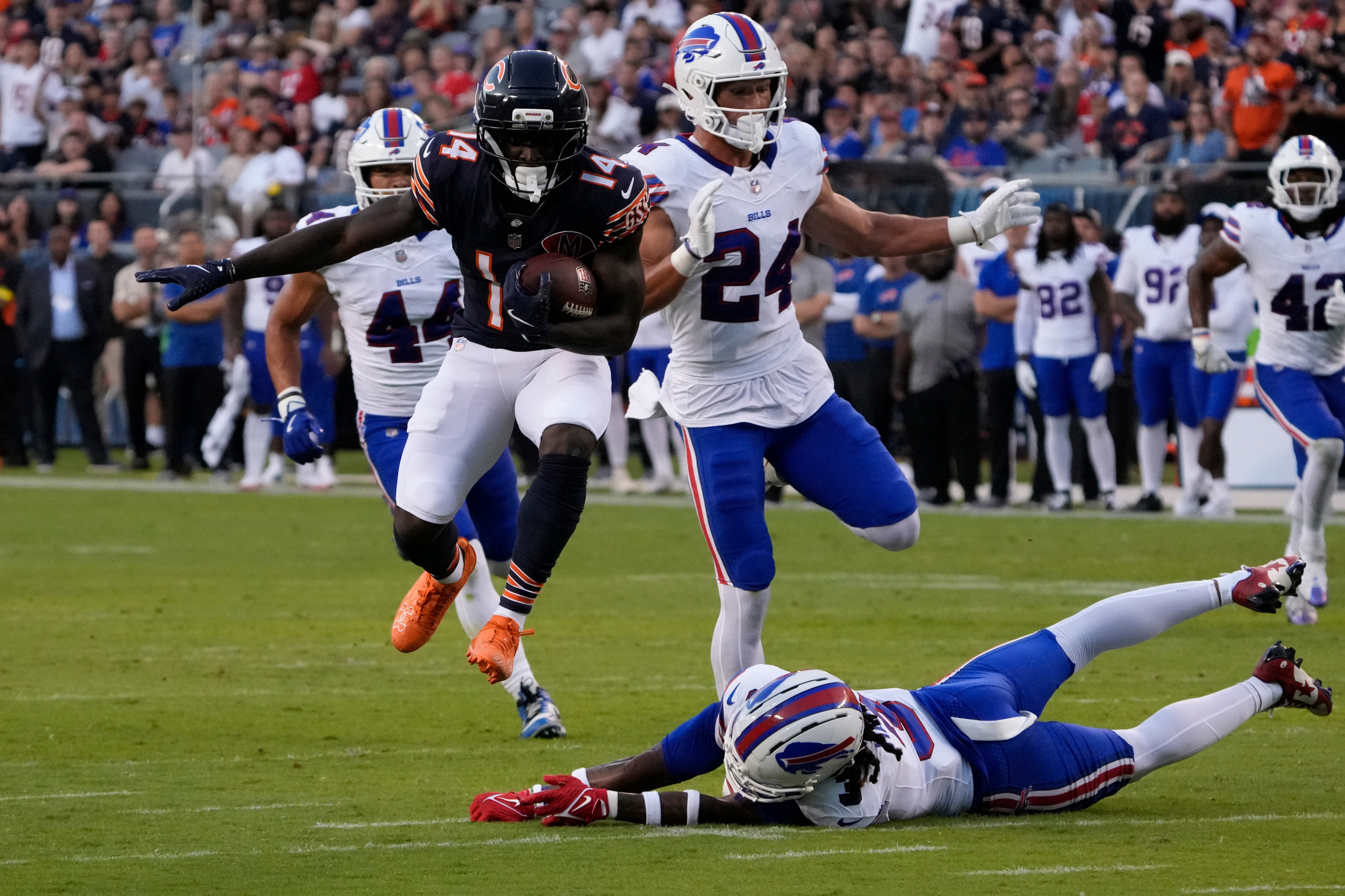Aug 17, 2025; Chicago, Illinois, USA; Chicago Bears wide receiver Olamide Zaccheaus (14) catches a touchdown pass as Buffalo Bills safety Damar Hamlin (3) tries to tackle him during the first quarter at Soldier Field.