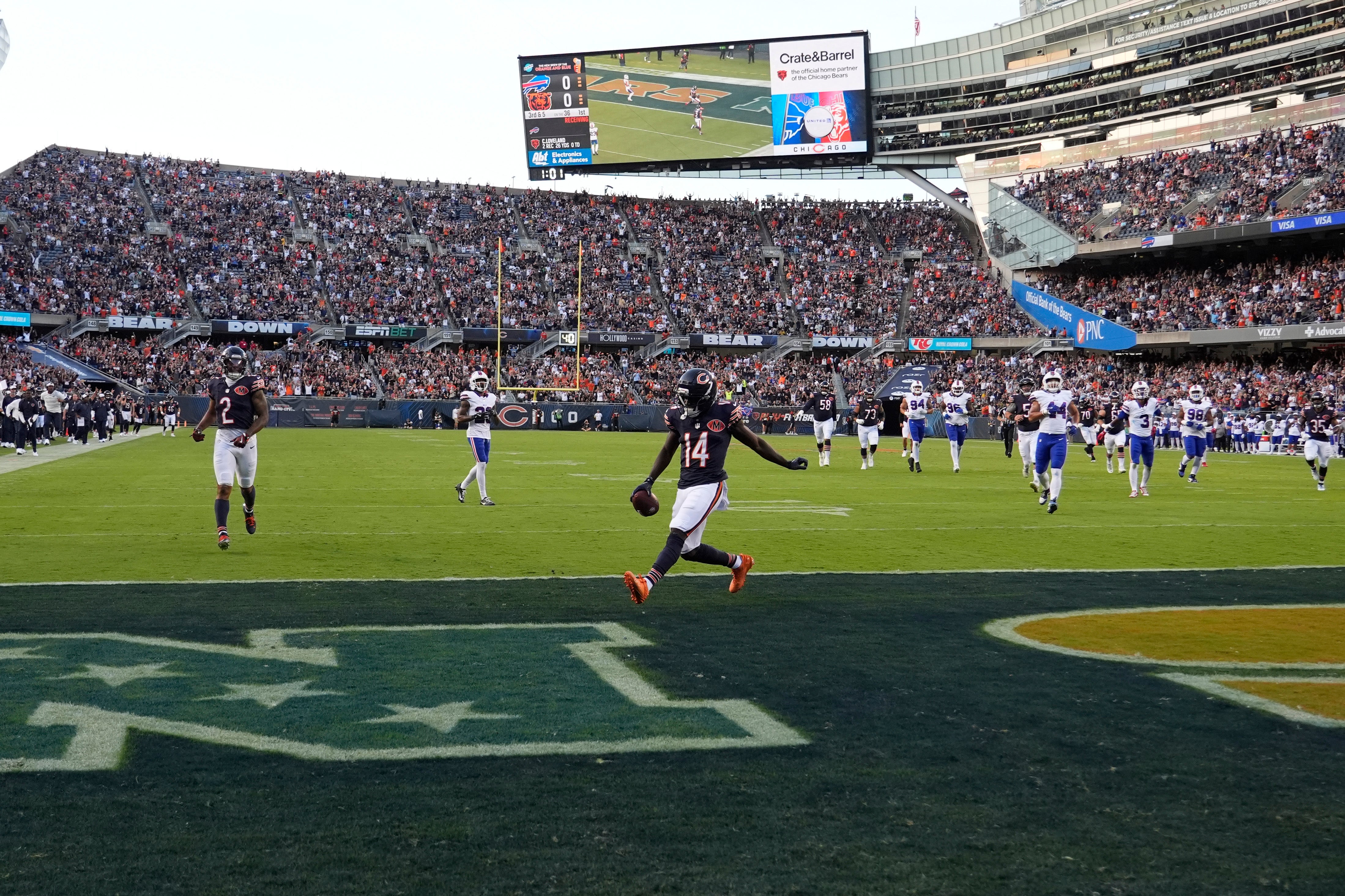 Aug 17, 2025; Chicago, Illinois, USA; Chicago Bears wide receiver Olamide Zaccheaus (14) celebrates his touchdown reception against the Buffalo Bills during the first quarter at Soldier Field.