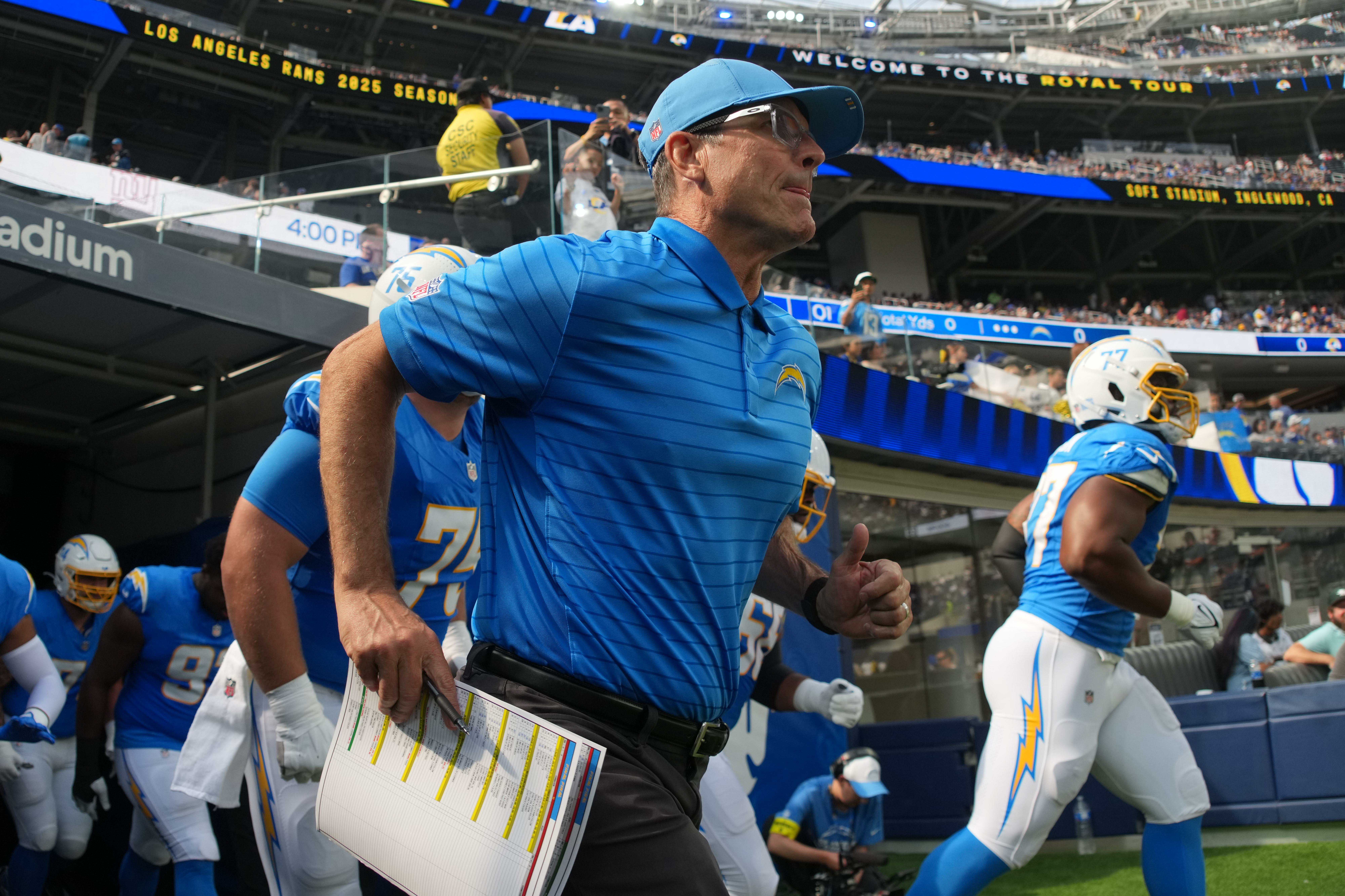 Aug 16, 2025; Inglewood, California, USA; Los Angeles Chargers coach Jim Harbaugh enters the field before the game against the Los Angeles Rams at SoFi Stadium. Mandatory Credit: Kirby Lee-Imagn Images