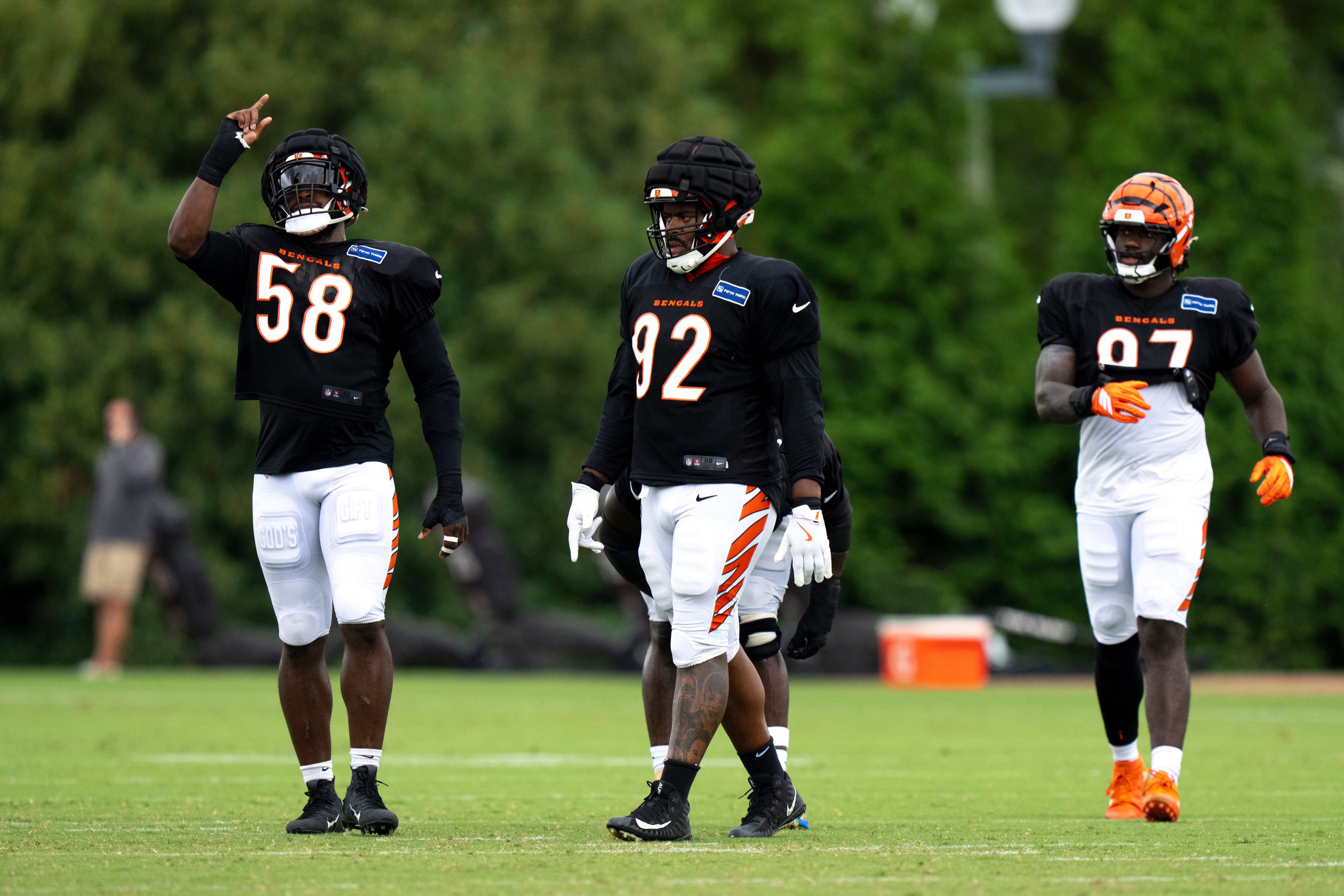 Cincinnati Bengals defensive end Joseph Ossai (58) and Cincinnati Bengals defensive tackle B.J. Hill (92) walk together during Cincinnati Bengals Practice in Cincinnati on Aug. 21, 2025.