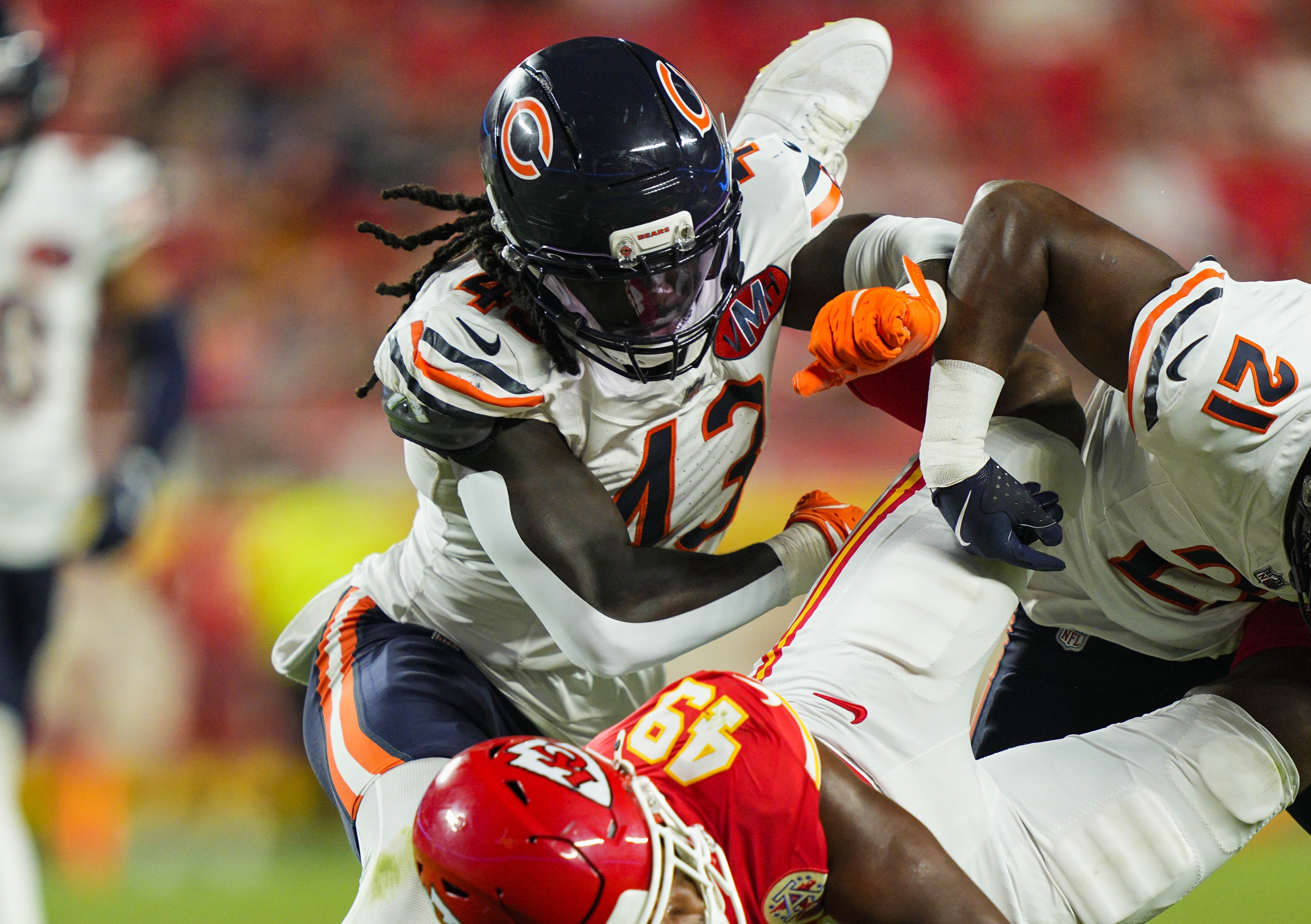 Aug 22, 2025; Kansas City, Missouri, USA; Kansas City Chiefs tight end Tre Watson (49) is tackled by Chicago Bears linebacker Carl Jones (43) during the second half at GEHA Field at Arrowhead Stadium.