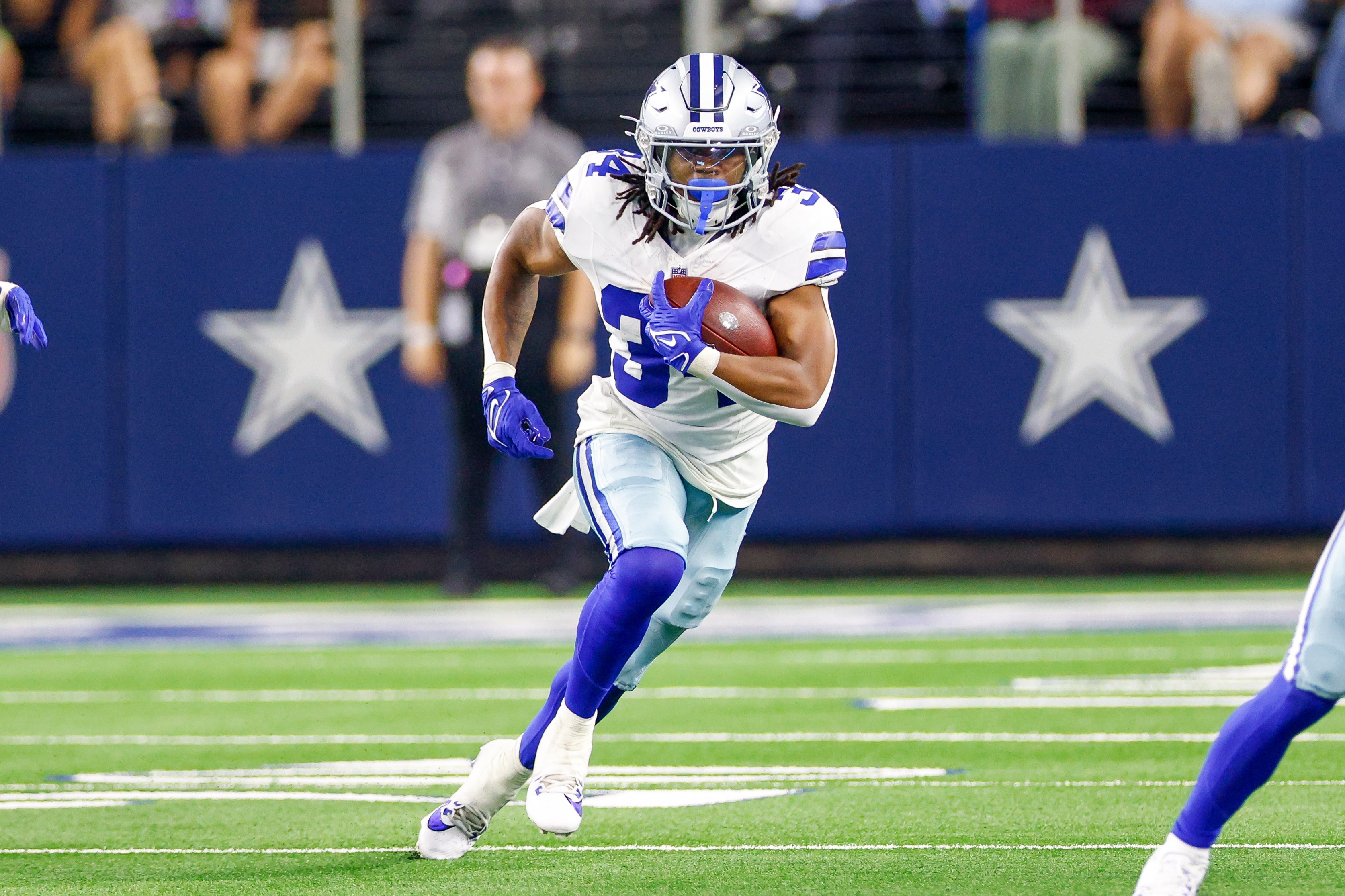 Dallas Cowboys running back Jaydon Blue (34) carries the ball during the fourth quarter against the Atlanta Falcons at AT&T Stadium.