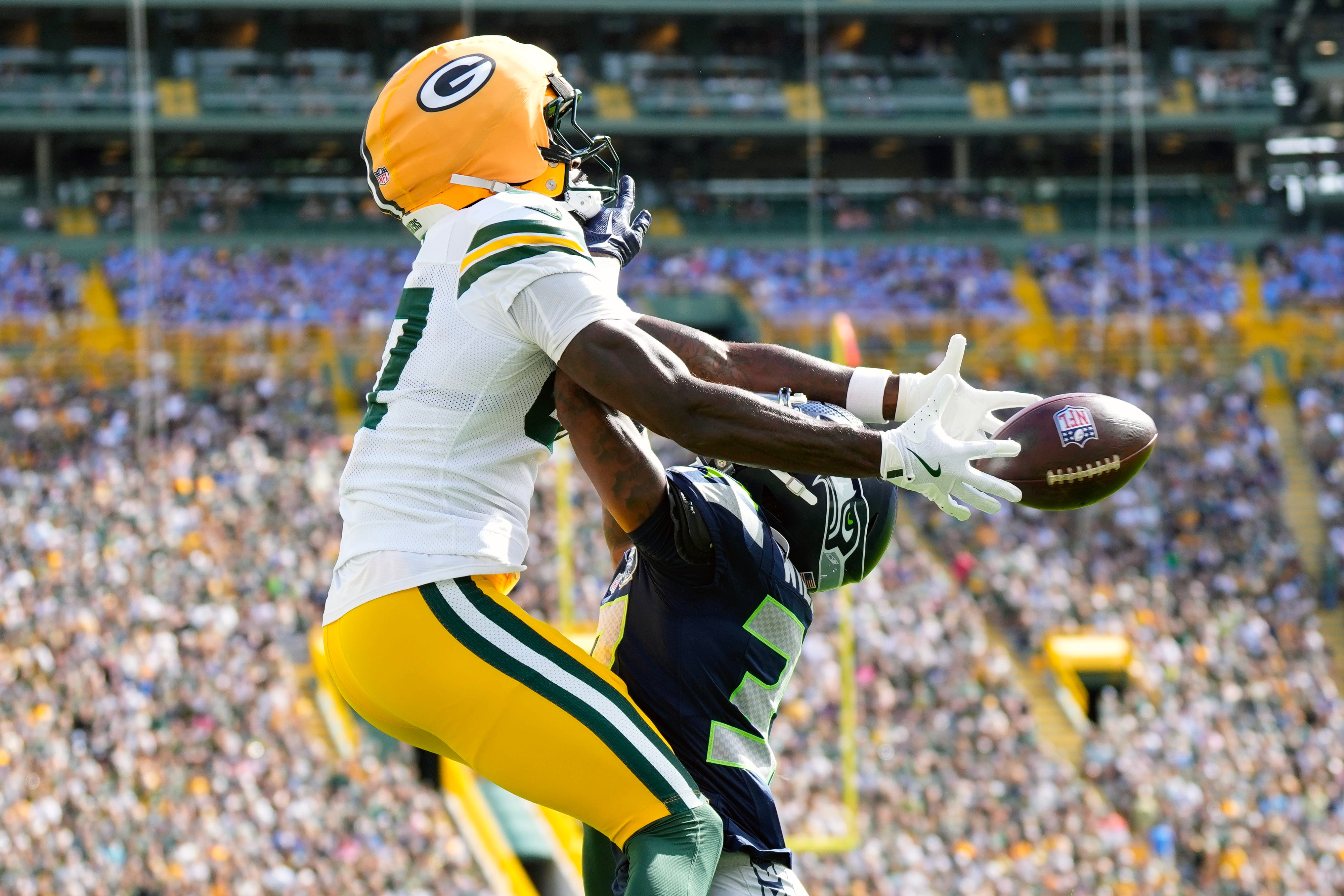 Aug 23, 2025; Green Bay, Wisconsin, USA; Seattle Seahawks cornerback Damarion Williams (37) commits a pass interference penalty as Green Bay Packers wide receiver Romeo Doubs (87) tries to catch a pass during the first quarter at Lambeau Field.